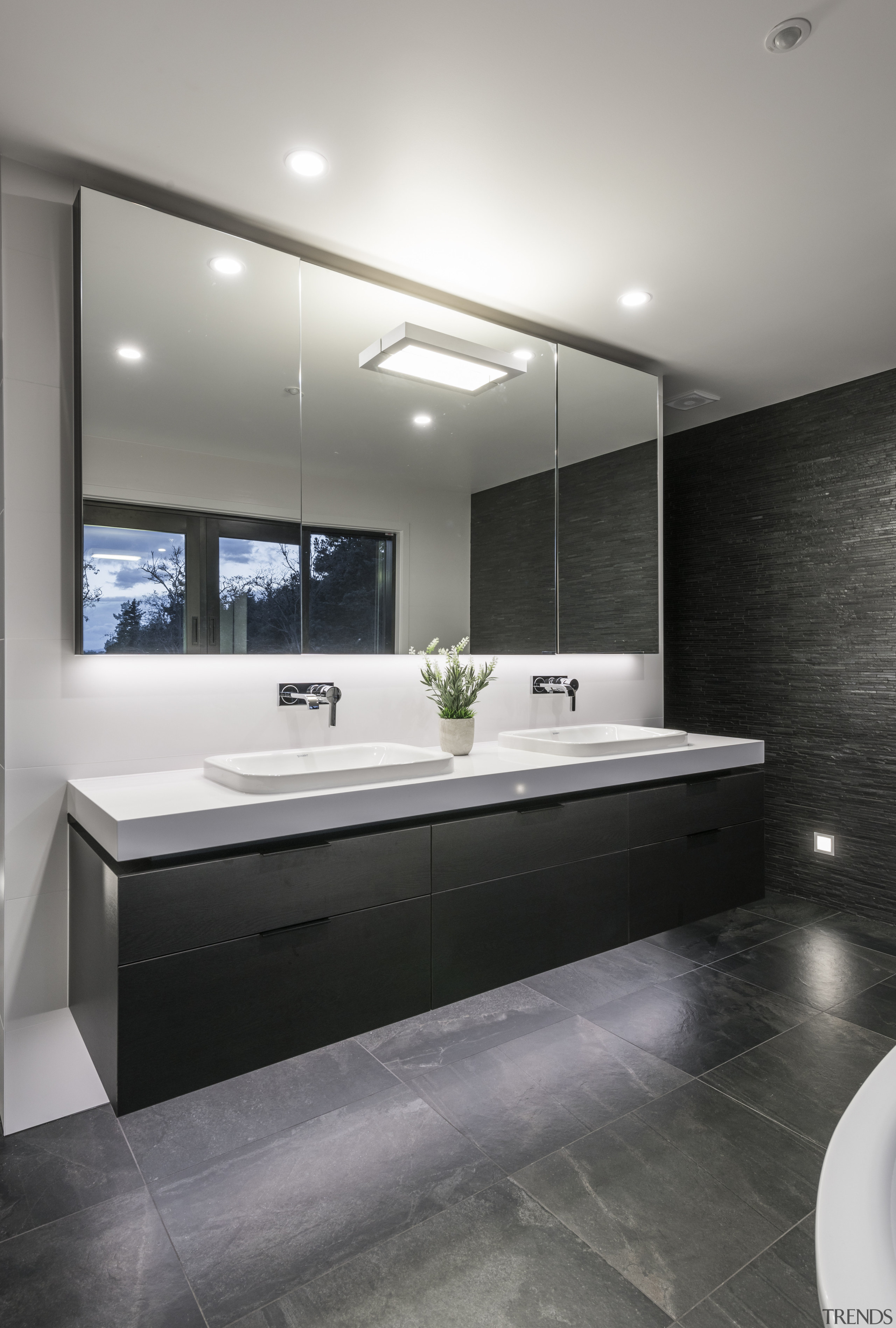 Under-vanity lighting highlights the stone-look flooring in this architecture, bathroom, ceiling, countertop, floor, interior design, product design, room, sink, gray, black