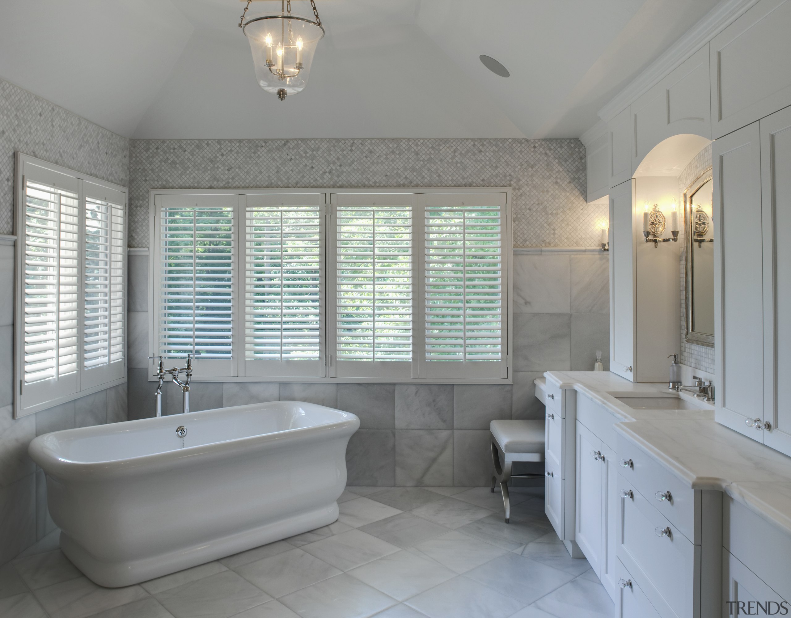 View of a Roman-styled bathroom which features a bathroom, bathtub, estate, floor, home, interior design, property, real estate, room, sink, tile, window, gray