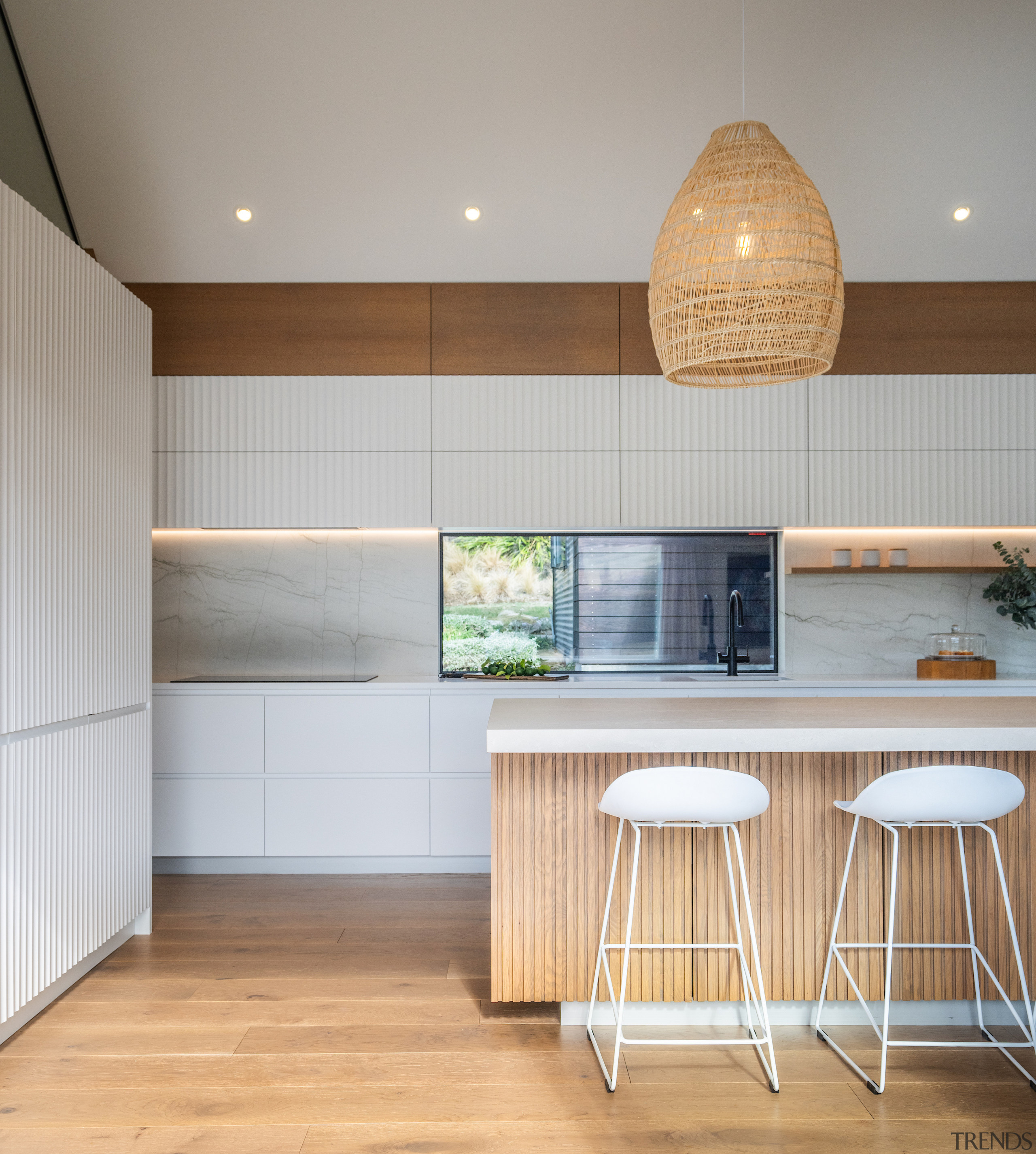 Wood flooring contrasts the white cabinetry while tying 