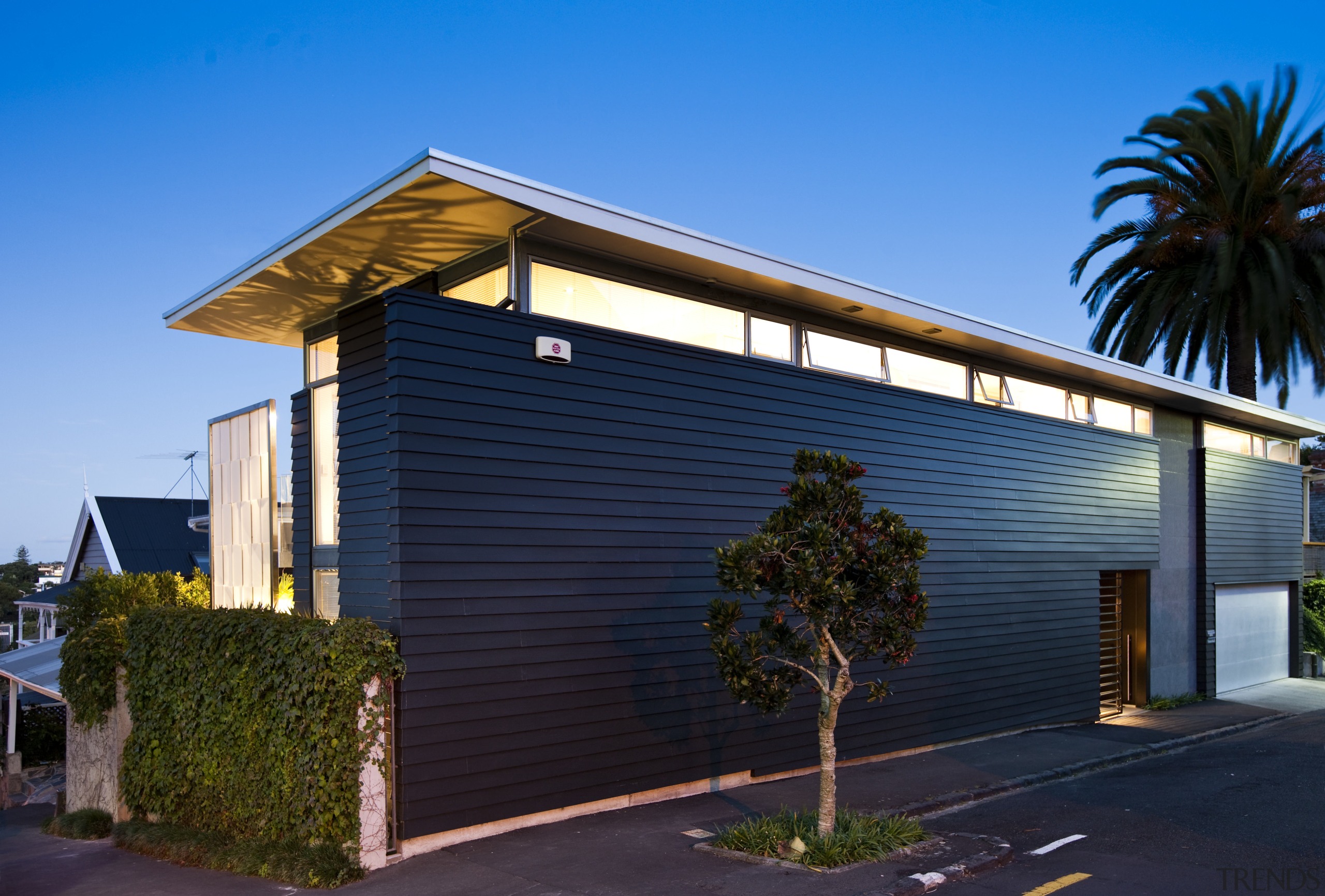 Exterior view of renovated home with black and architecture, building, commercial building, corporate headquarters, facade, home, house, property, real estate, residential area, roof, shed, siding, sky, teal, blue