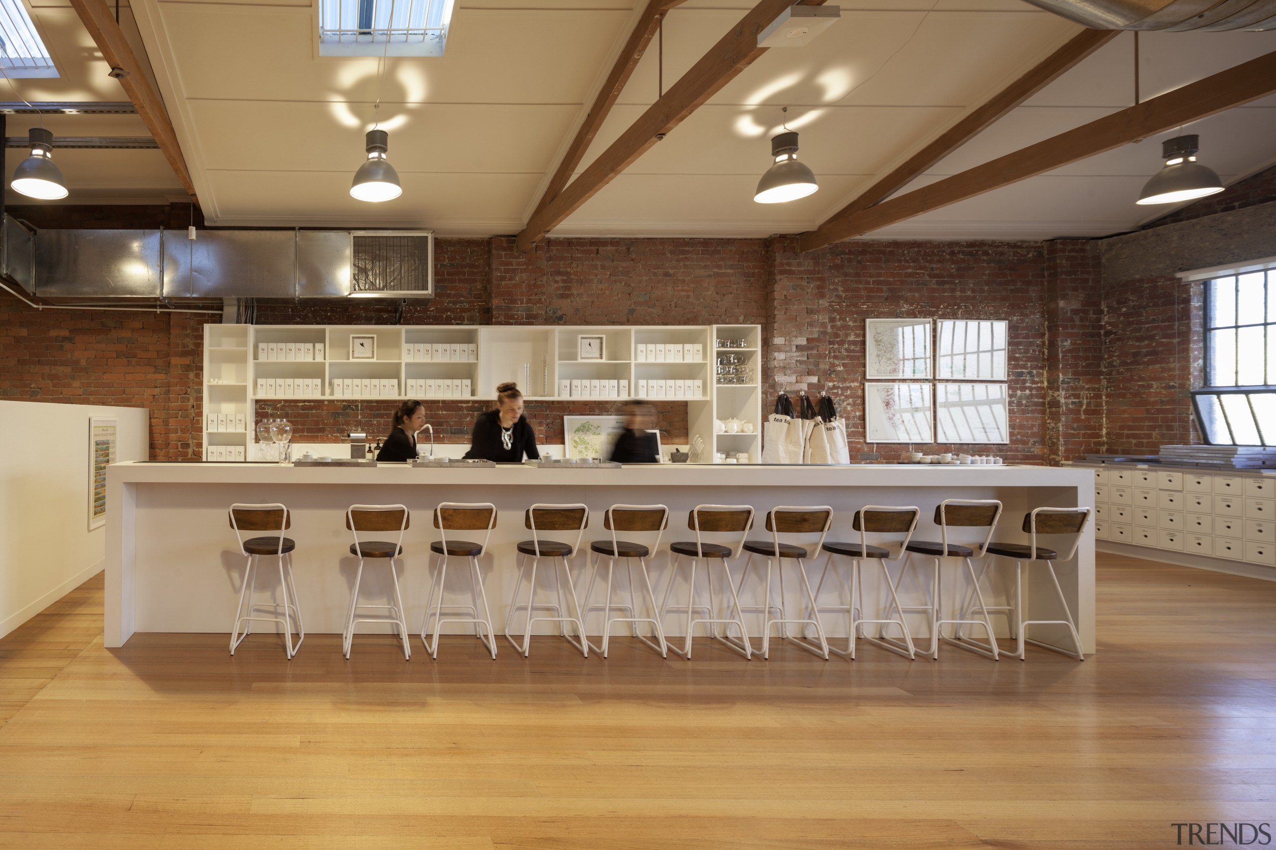 A former industrial warehouse in Melbourne is home ceiling, floor, flooring, function hall, furniture, hardwood, interior design, room, table, wood, wood flooring, orange, brown