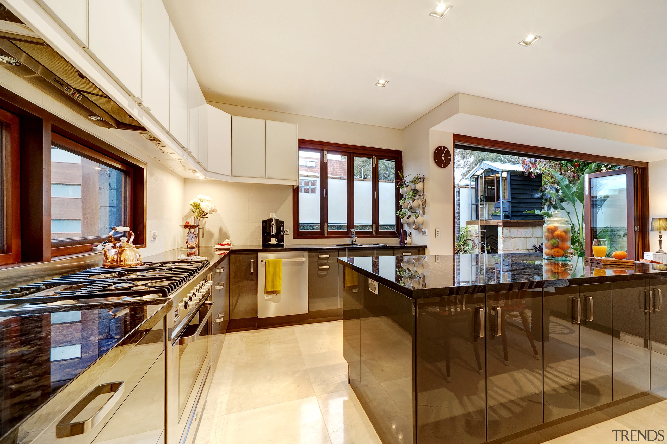 This kitchen wraps around two walls and includes ceiling, countertop, estate, home, interior design, kitchen, property, real estate, white