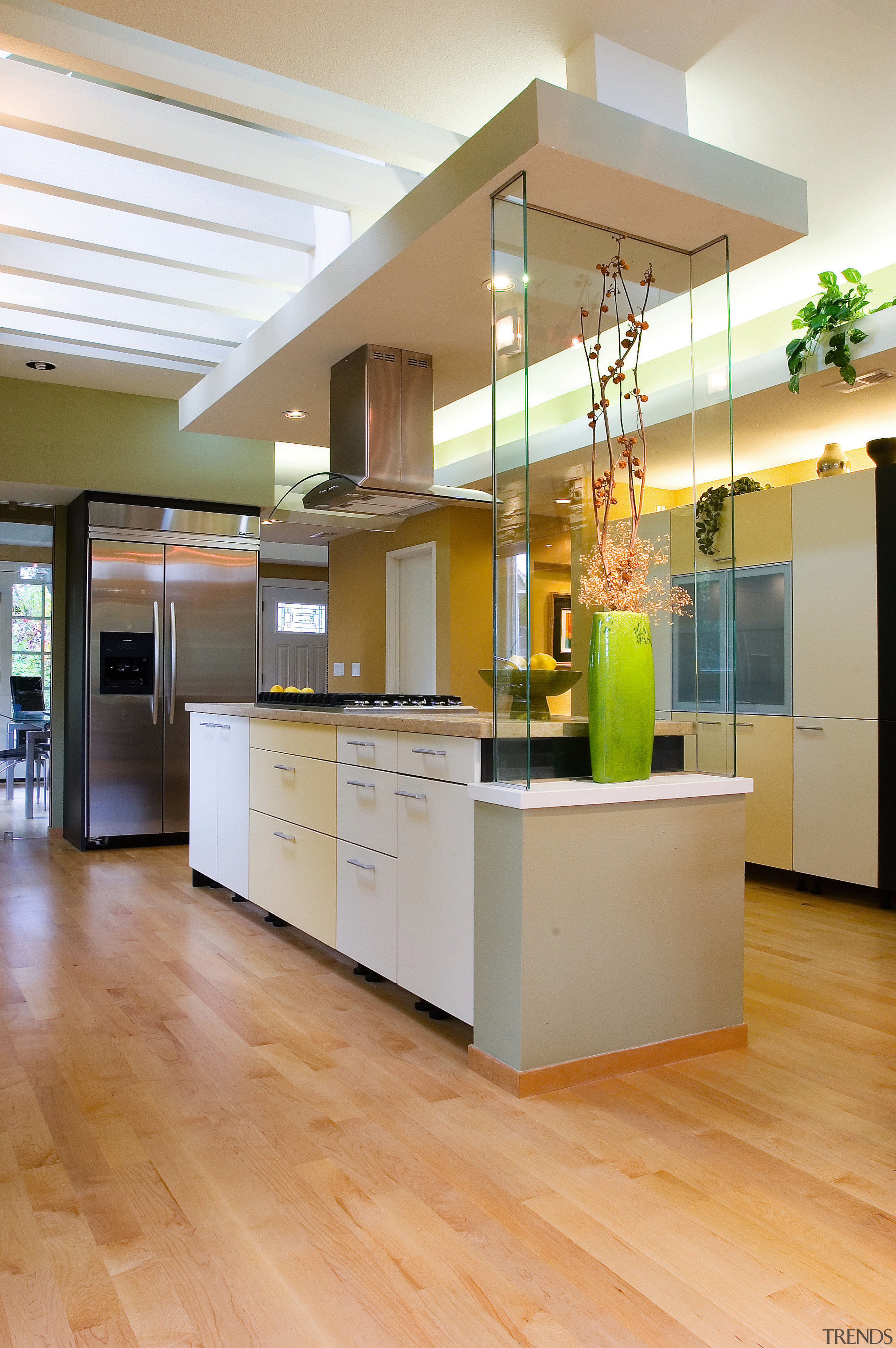 A view of this modern kitchen designed by cabinetry, ceiling, countertop, floor, flooring, hardwood, interior design, kitchen, laminate flooring, wood flooring, orange