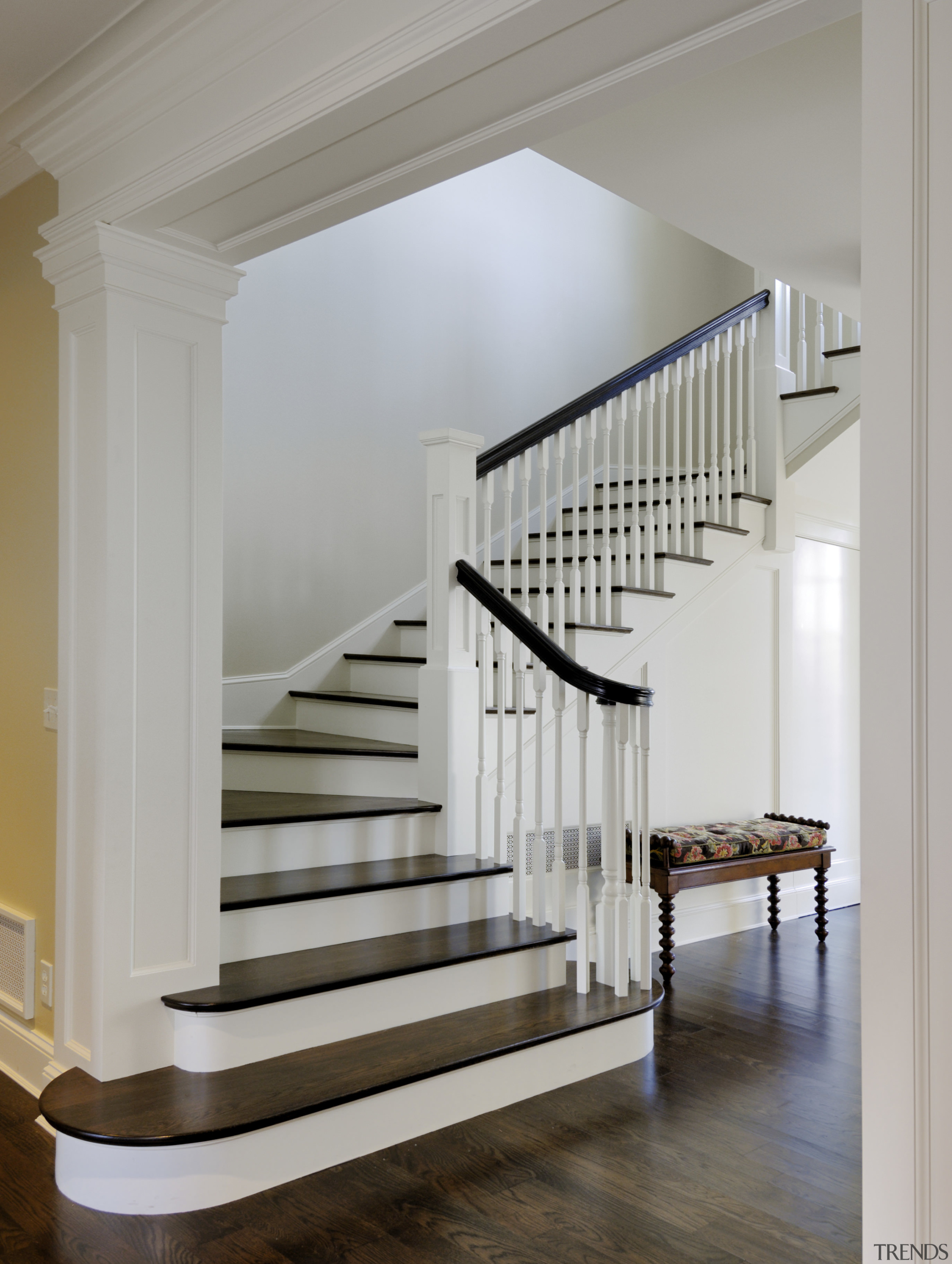 Image of the bottom of the wooden stairway baluster, floor, handrail, hardwood, home, interior design, stairs, structure, gray