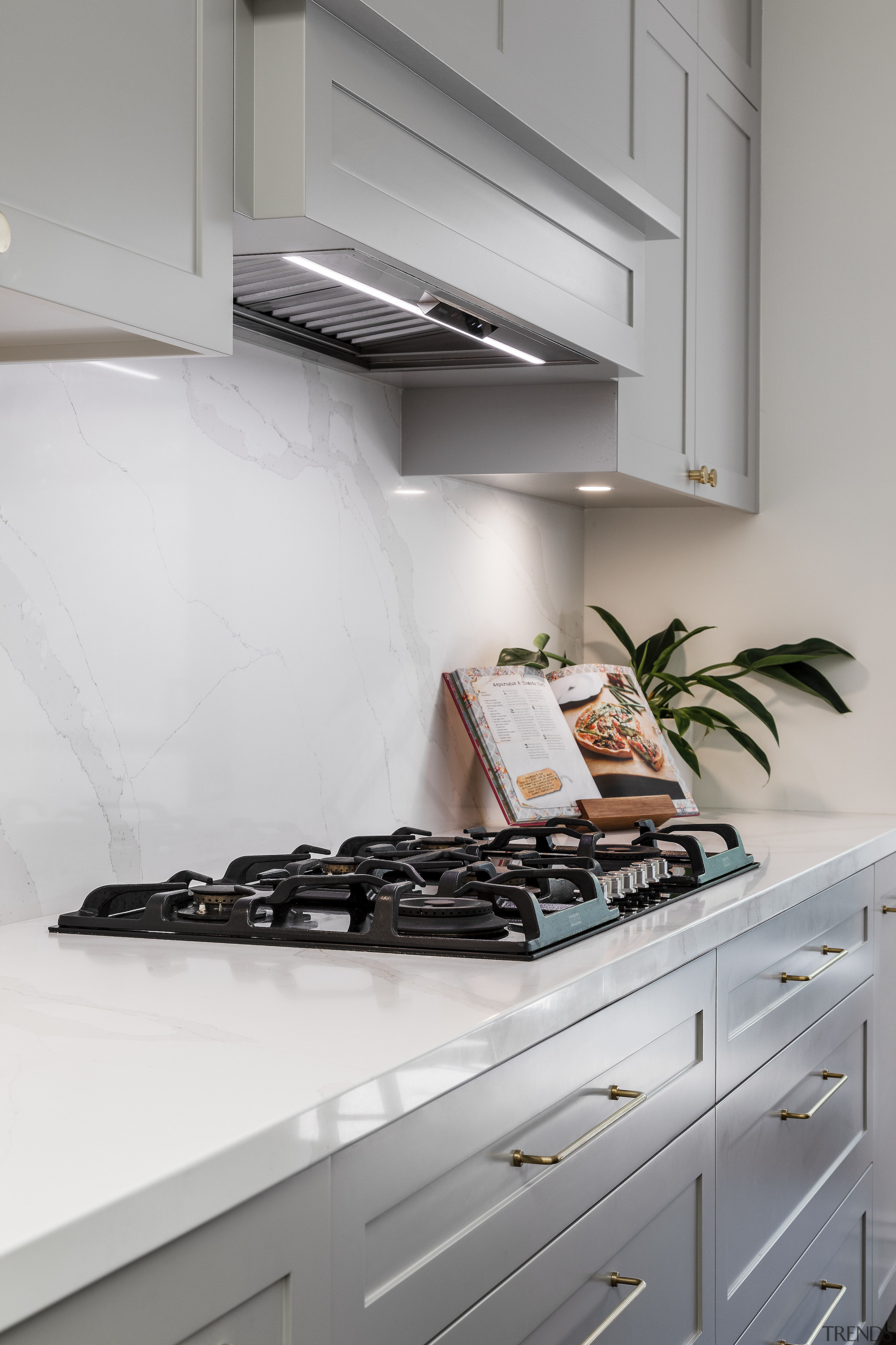 The rangehood is absorbed into the cabinetry. 