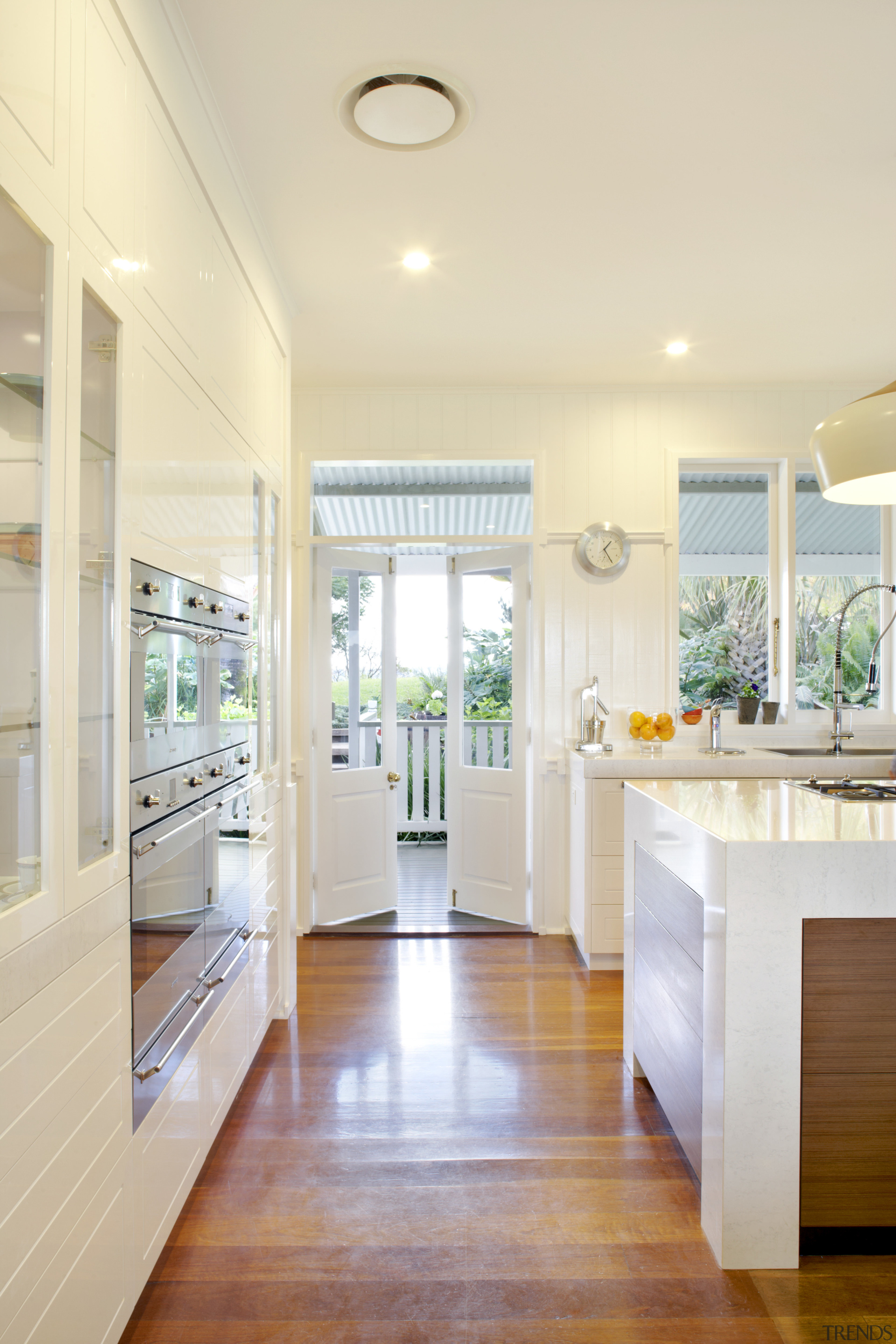 The end of the island beside the oven ceiling, countertop, daylighting, estate, floor, flooring, hardwood, home, interior design, kitchen, real estate, room, window, wood flooring, orange