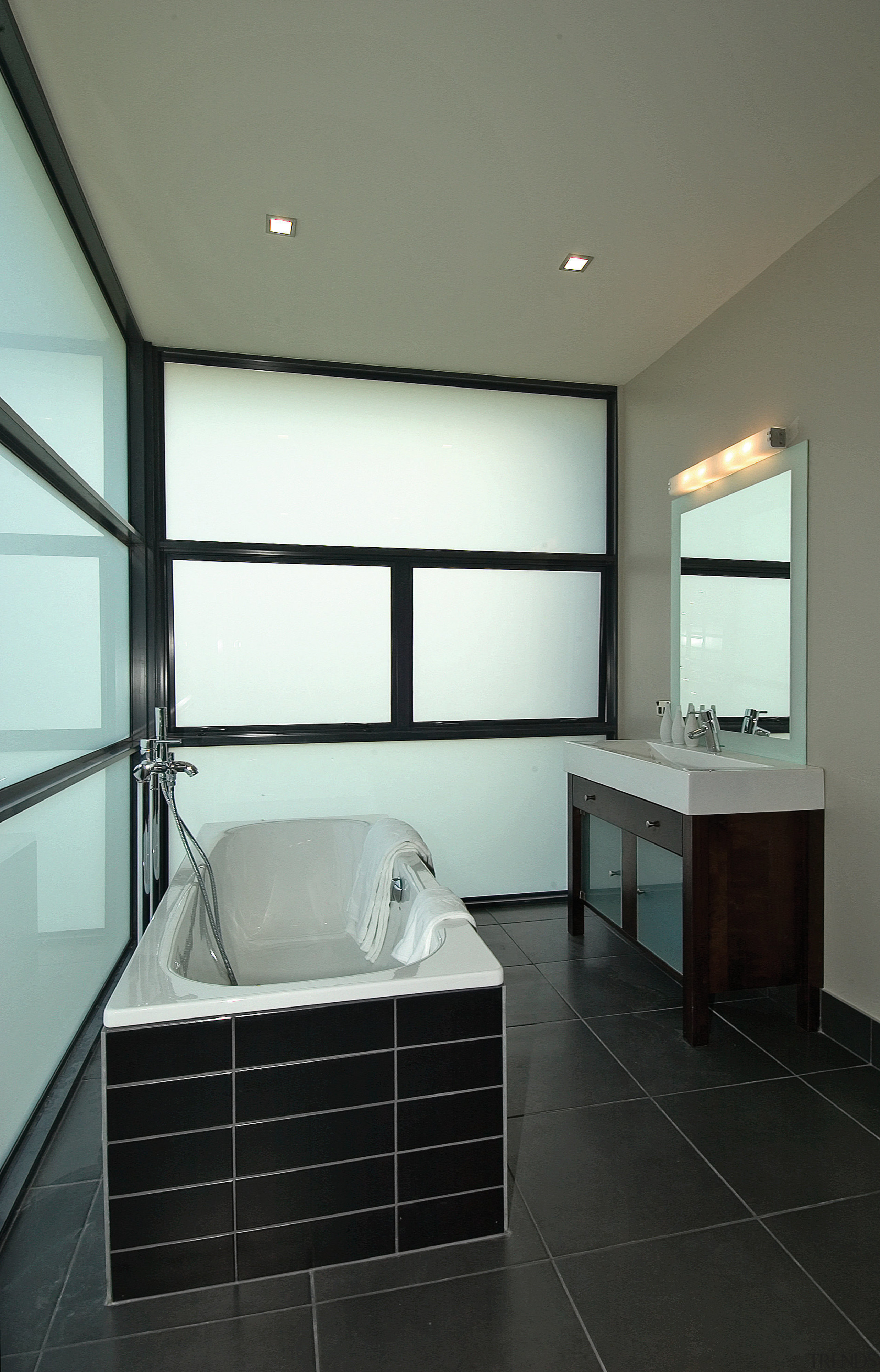 Bathroom with black tiled bath surround, white screen architecture, bathroom, ceiling, daylighting, floor, glass, house, interior design, real estate, room, sink, window, gray, black