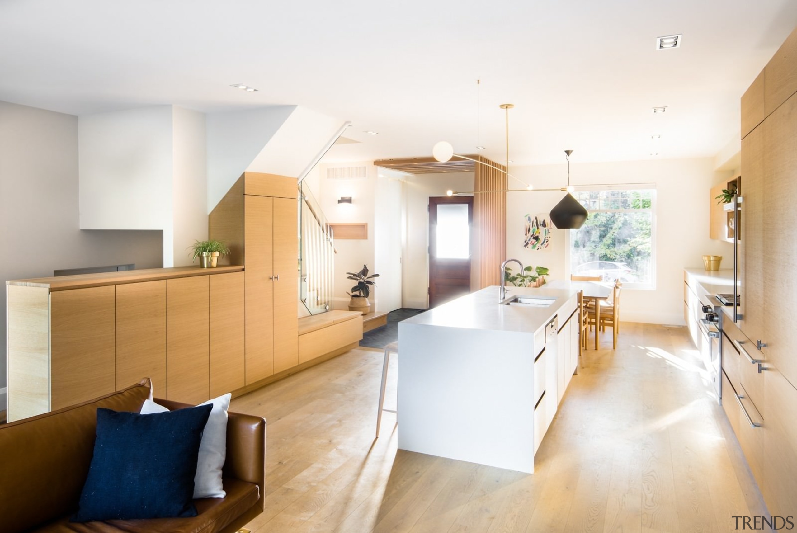 A white island draws the eye in this architecture, ceiling, daylighting, floor, home, house, interior design, interior designer, kitchen, living room, real estate, room, white