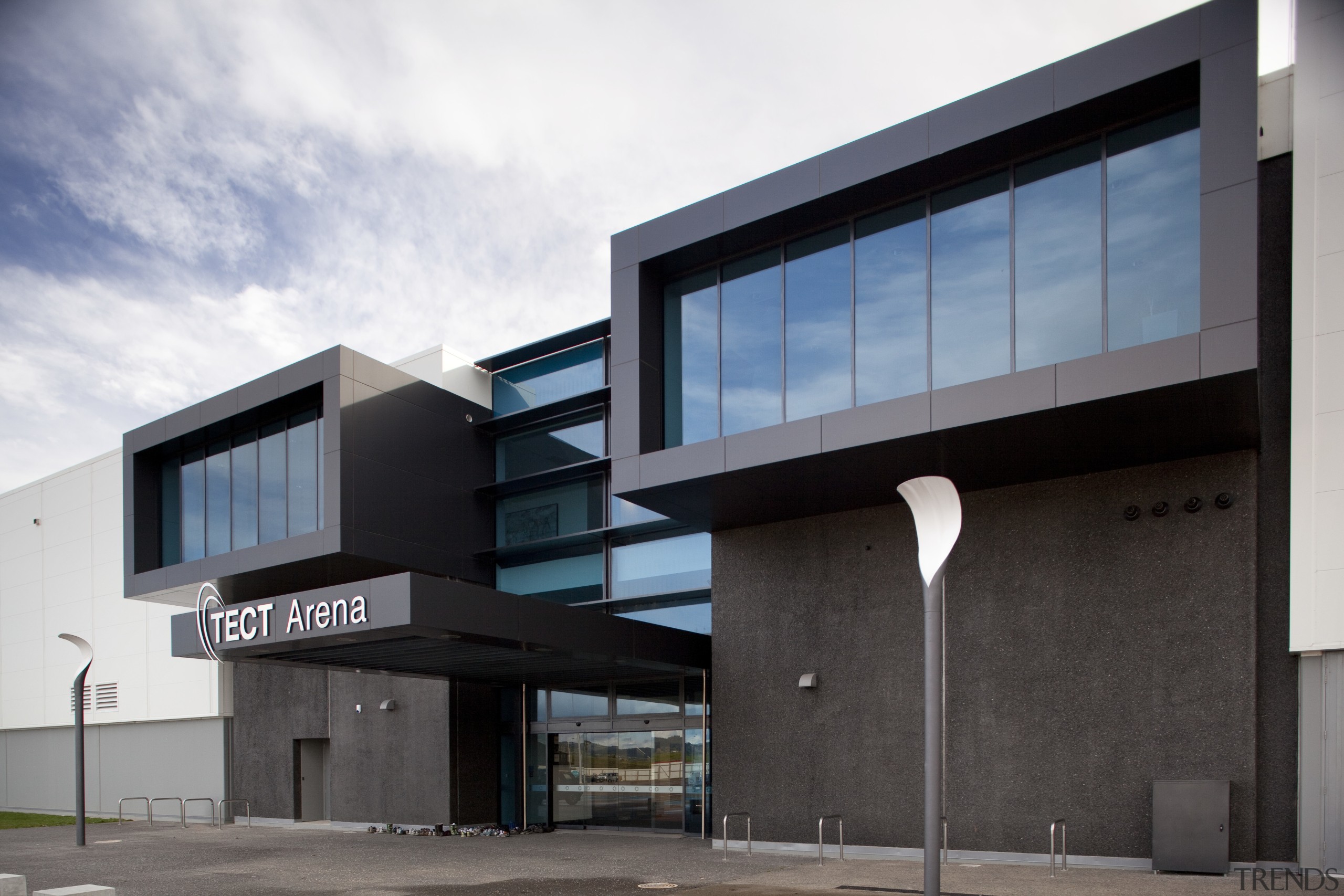 TECT Arena building with dark grey cladding. - architecture, building, commercial building, corporate headquarters, facade, house, property, real estate, black, white