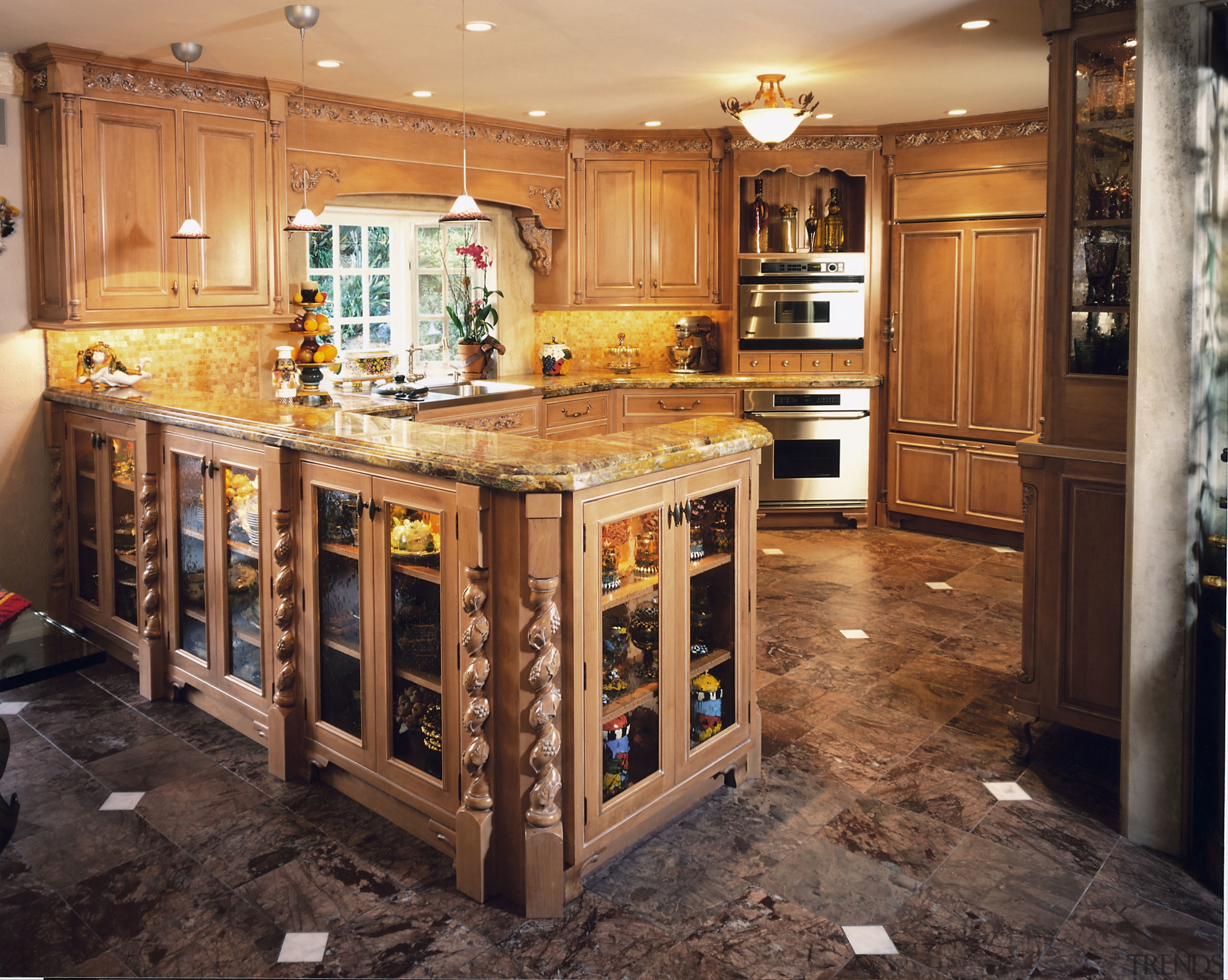 A view of a kitchen, brown and white cabinetry, countertop, cuisine classique, flooring, kitchen, room, orange, black, brown