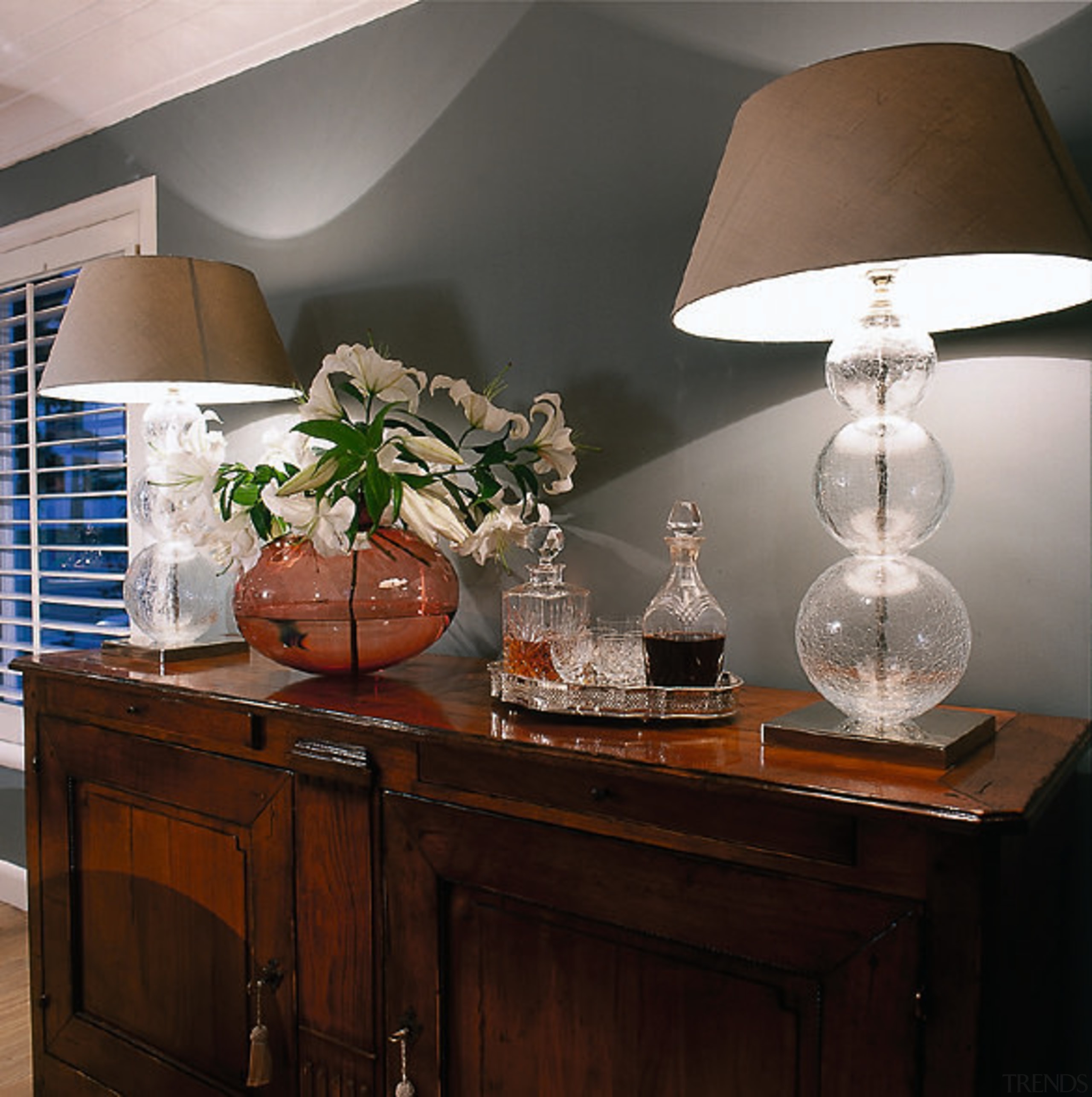 A view of crystal lamps and teahouse coloured chandelier, furniture, home, interior design, lamp, lampshade, light fixture, lighting, lighting accessory, living room, room, table, black, gray