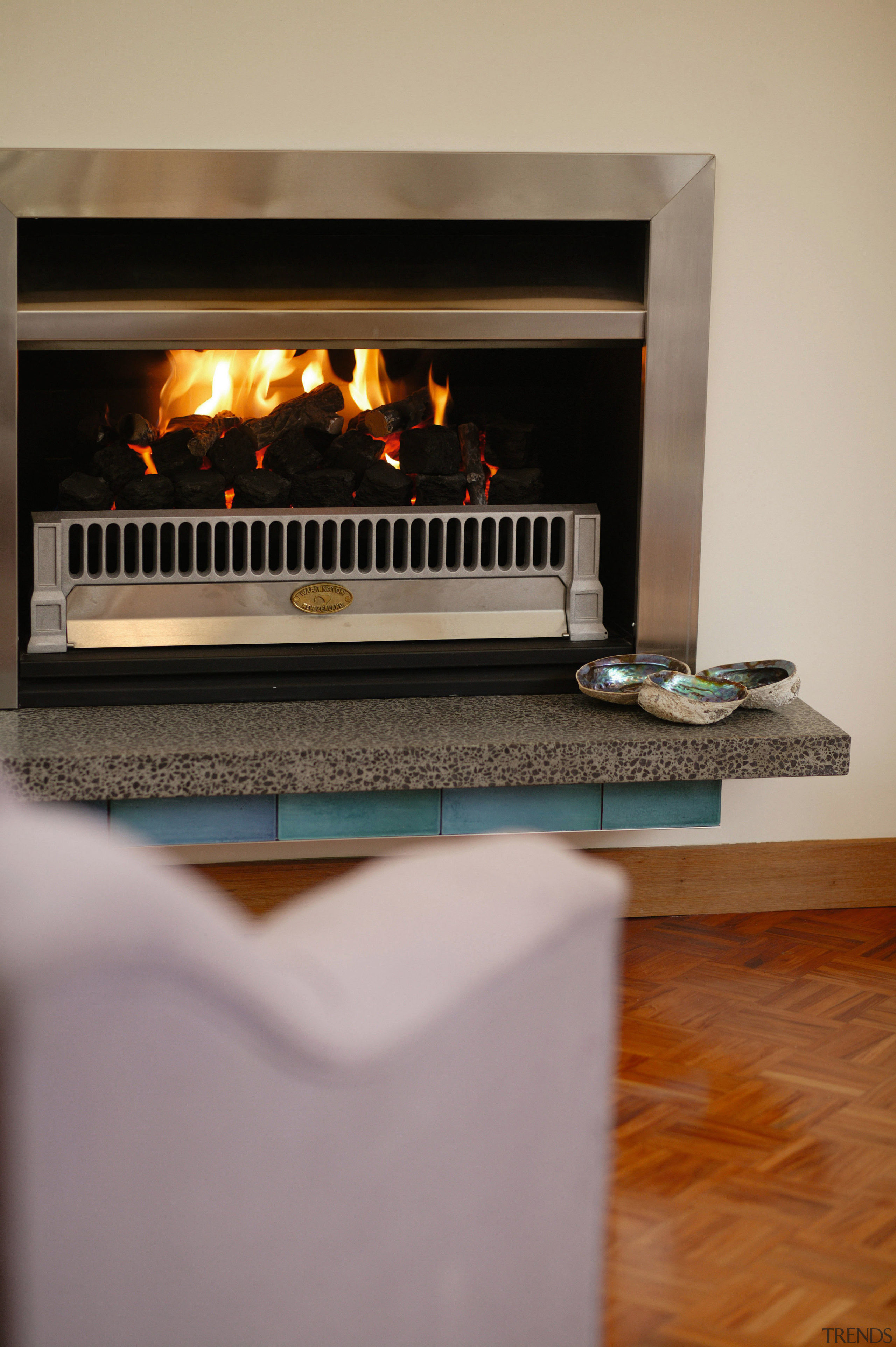 Gas fire with stainless steel surround, and stone fireplace, hearth, gray