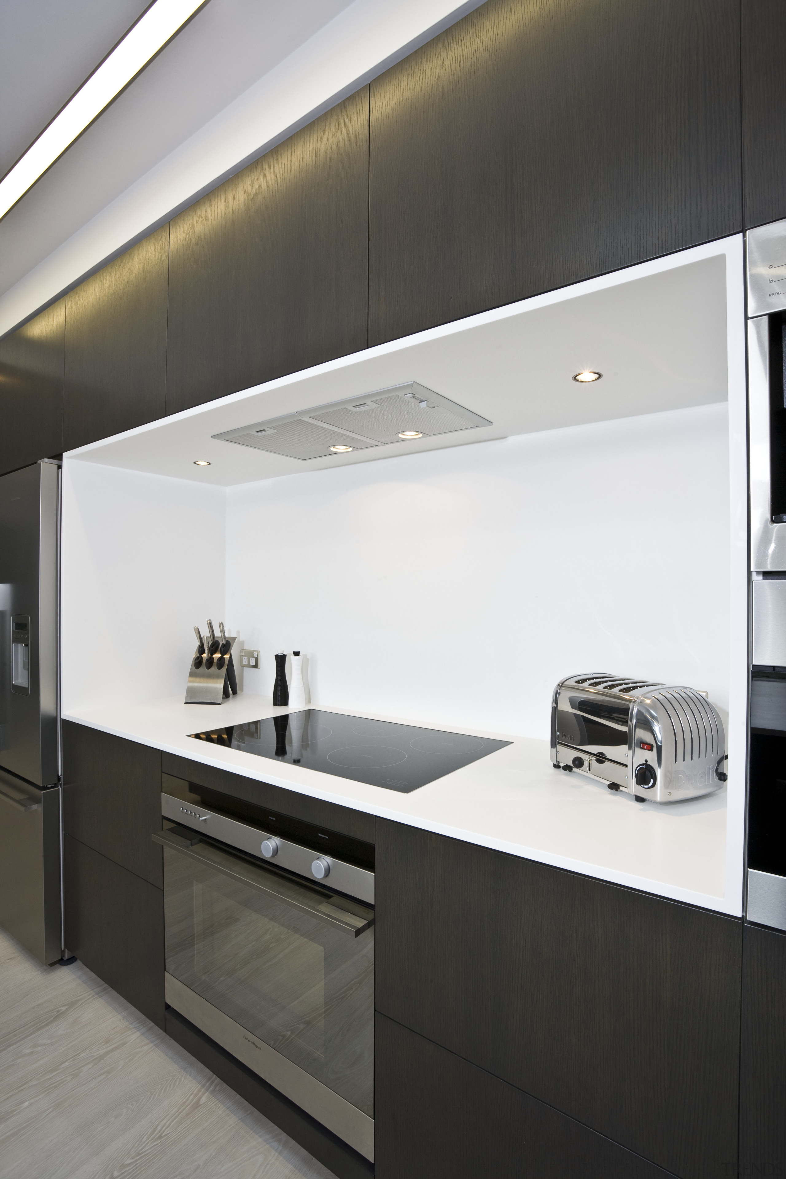 View of kitchen featuring dark-stained oak cabinetry, appliances, cabinetry, countertop, home appliance, interior design, kitchen, product design, black, white