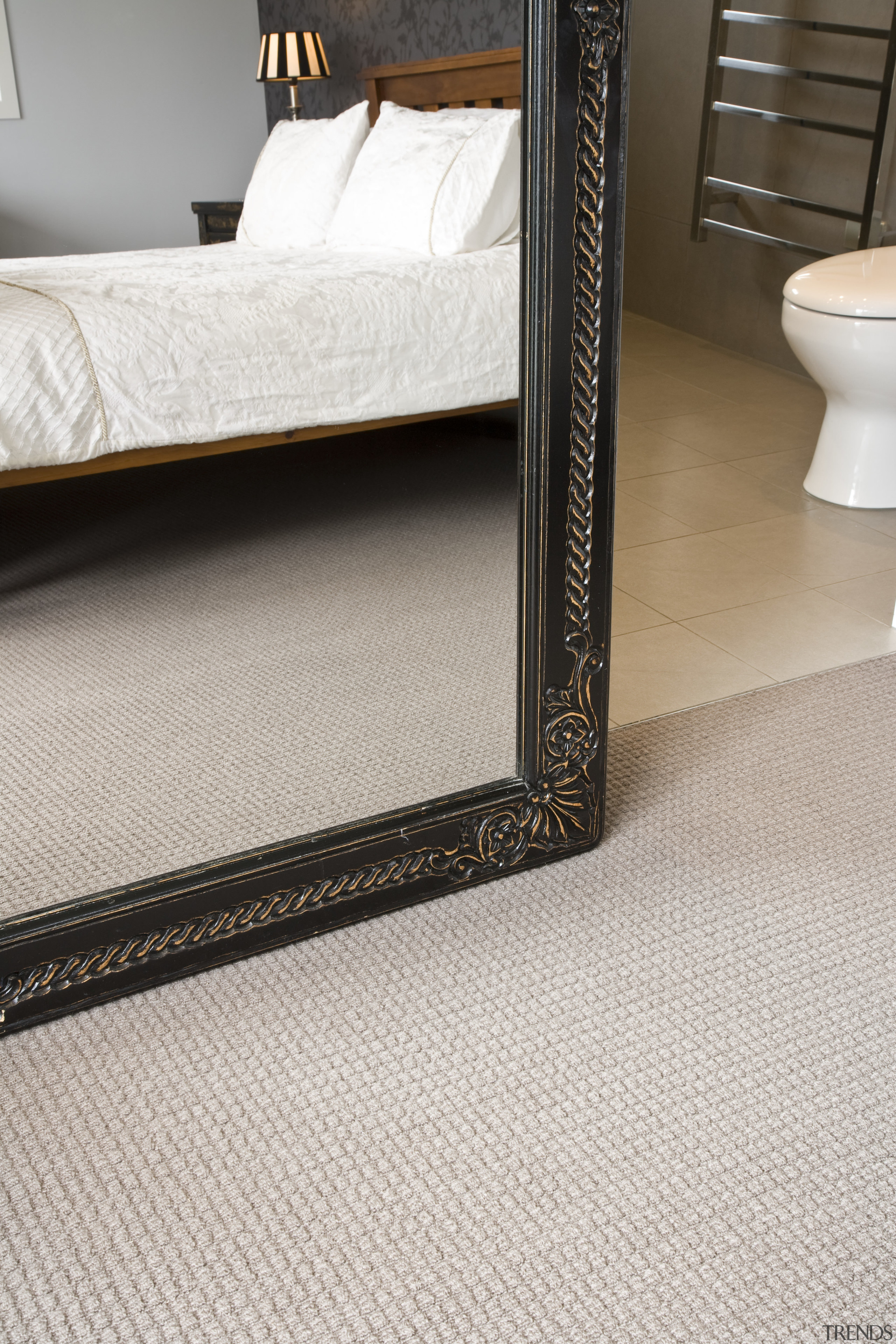 View of a bedroom area which features pure carpet, floor, flooring, furniture, tile, wood, gray