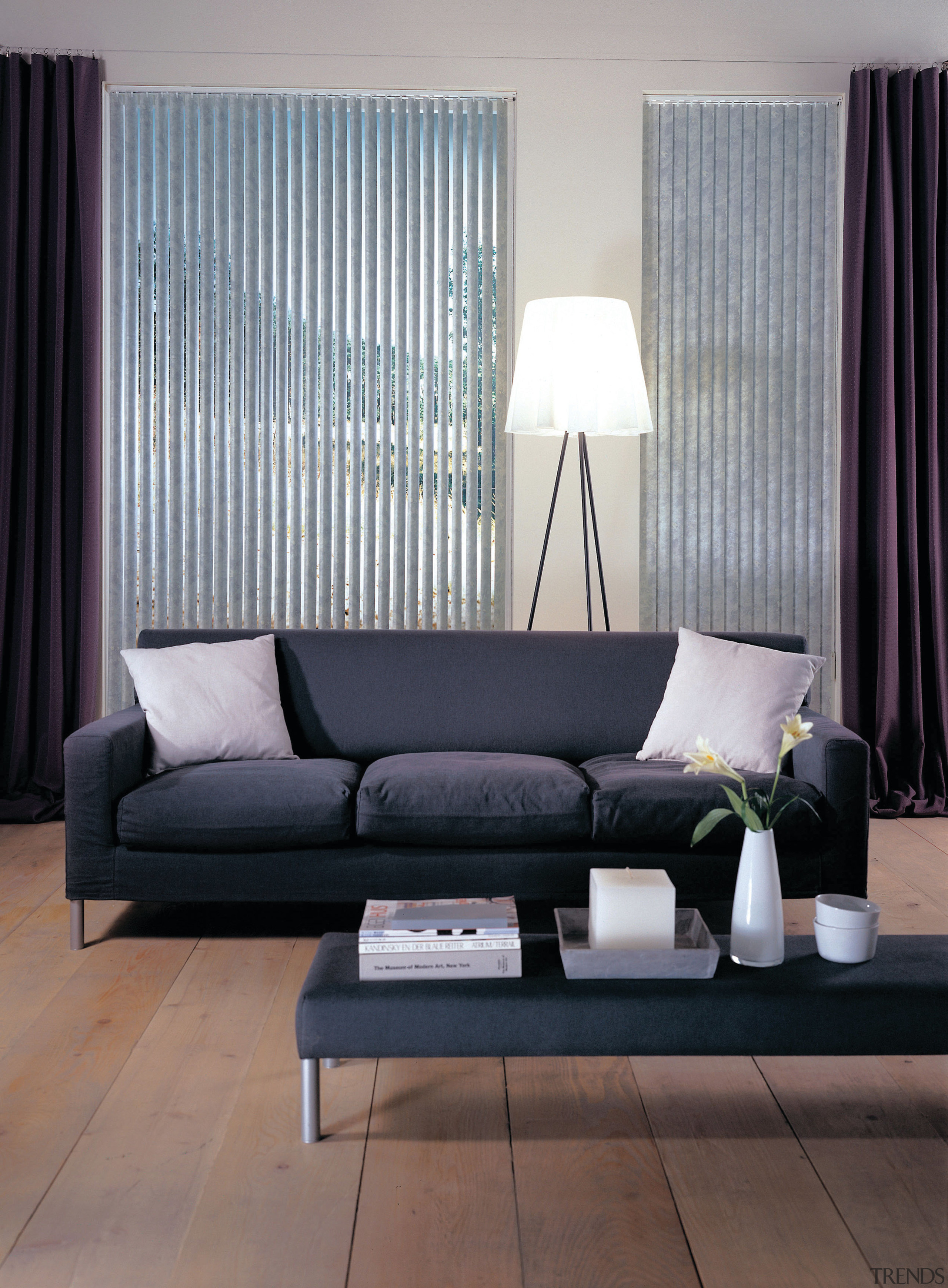 A view of the Luxaflex Verticals vanes that angle, coffee table, couch, curtain, floor, flooring, furniture, home, interior design, living room, loveseat, room, sofa bed, table, wall, window, window blind, window covering, window treatment, gray, black