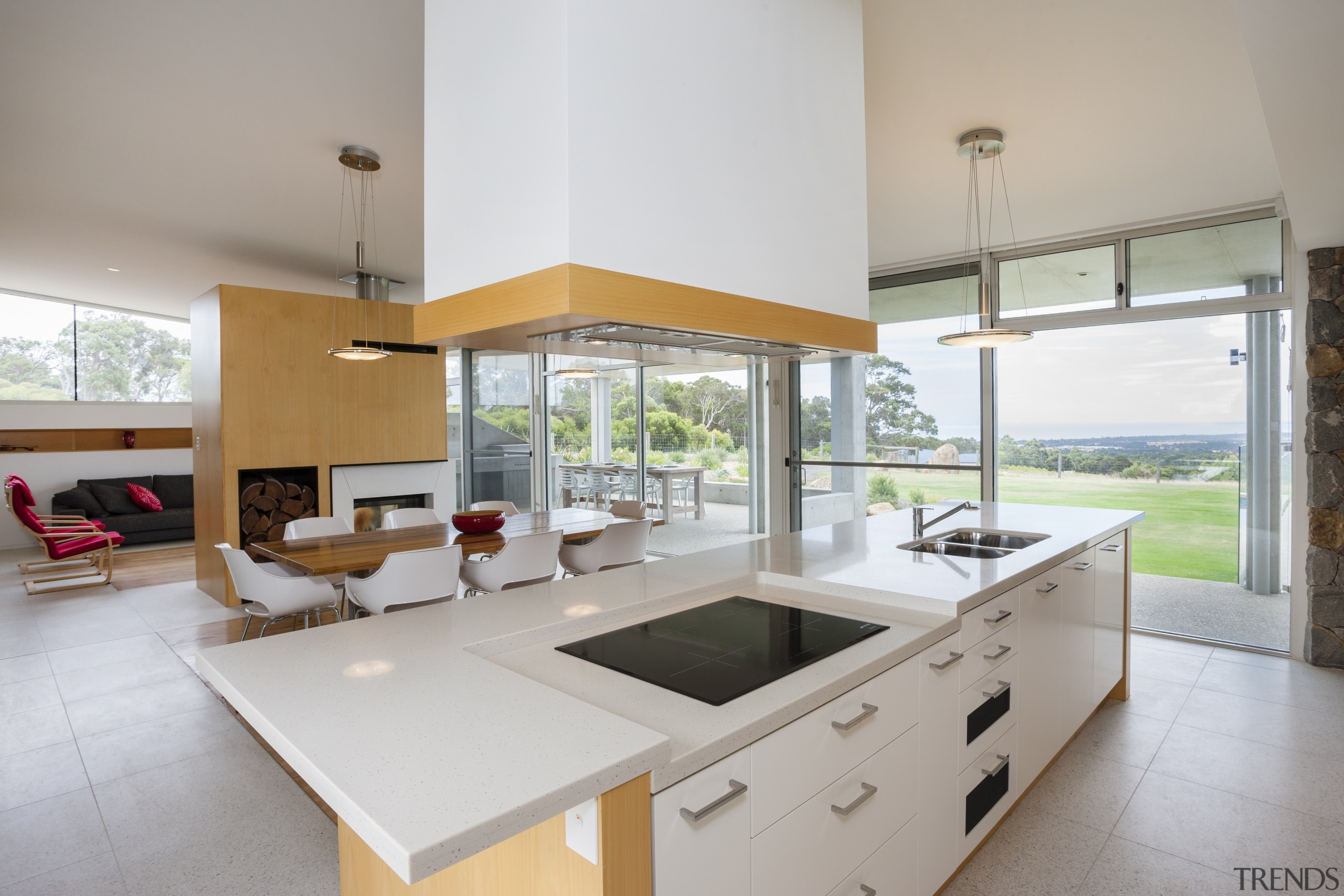 A white kitchen island, with hanging extractor sits architecture, countertop, estate, house, interior design, kitchen, property, real estate, window, gray