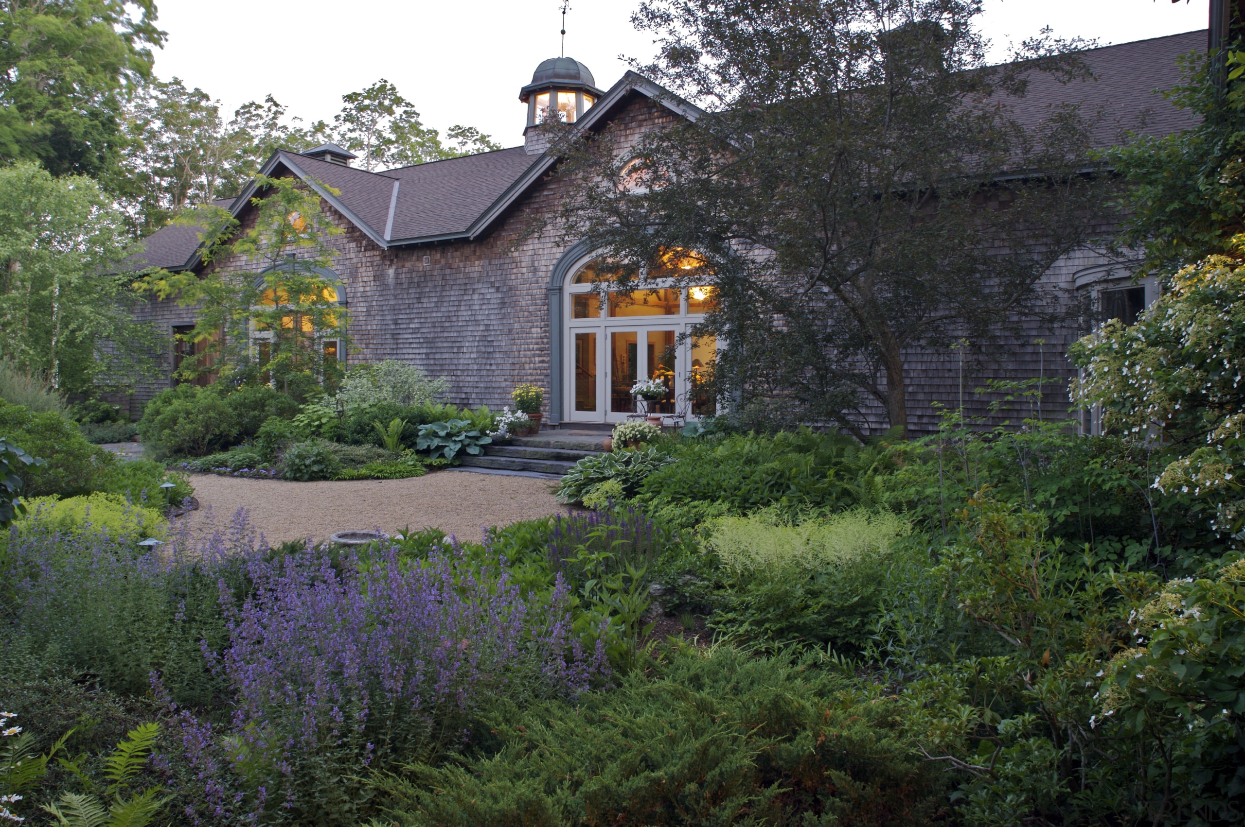 Exterior view of the house and also showing cottage, estate, facade, farmhouse, garden, home, house, landscape, landscaping, mansion, plant, property, real estate, tree, yard, green, black