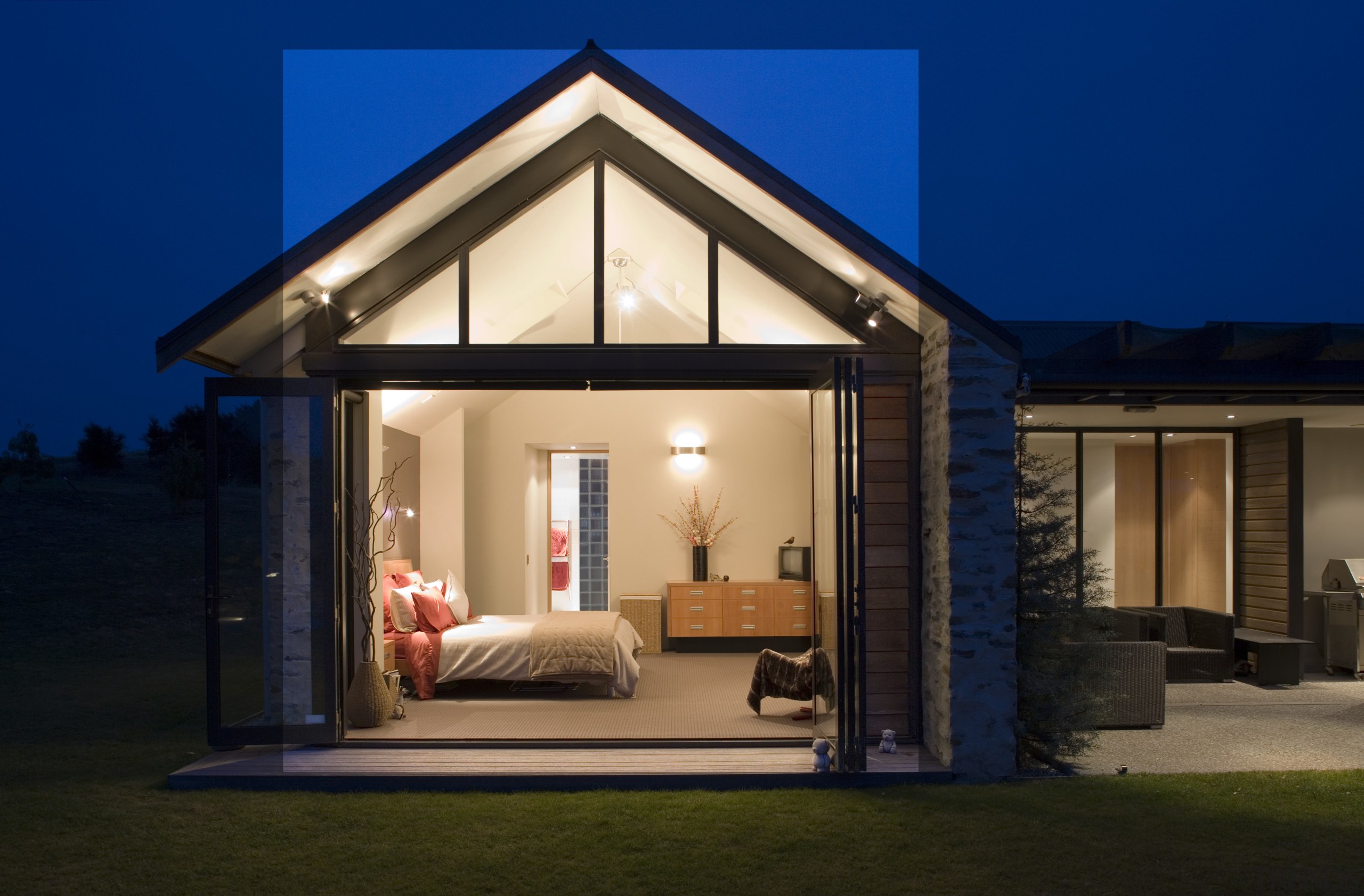 An extension of the schist wall at one cottage, estate, facade, home, house, lighting, property, real estate, roof, window, black, blue