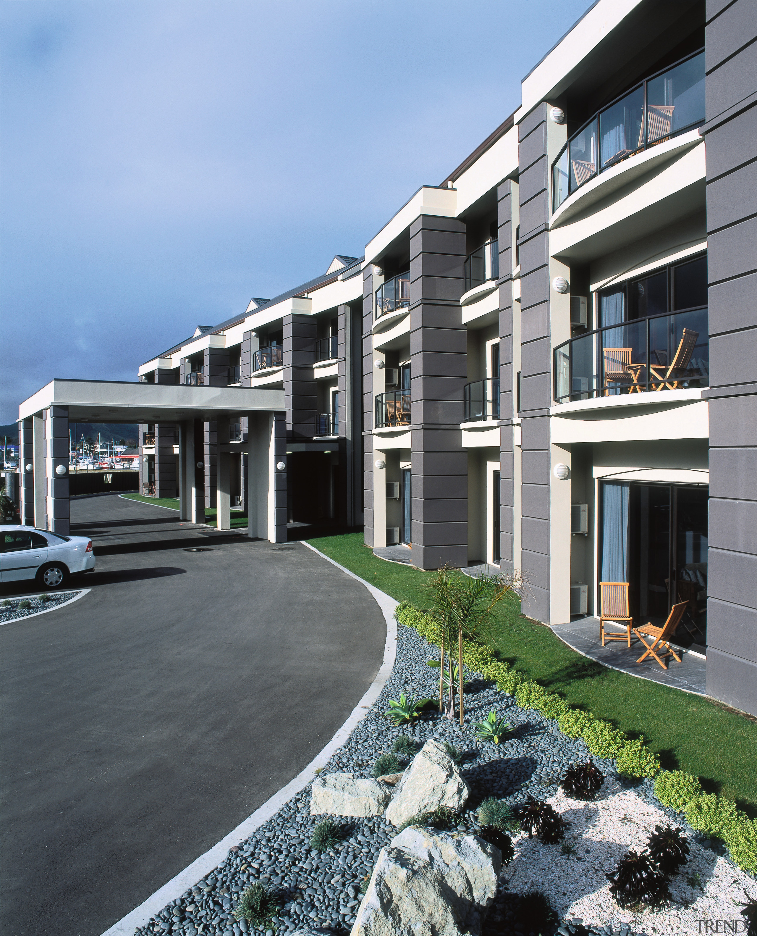 Exterior view of hotel entranceway with balconies at apartment, architecture, building, condominium, corporate headquarters, elevation, estate, facade, home, house, mixed use, neighbourhood, property, real estate, residential area, window, teal, gray, black