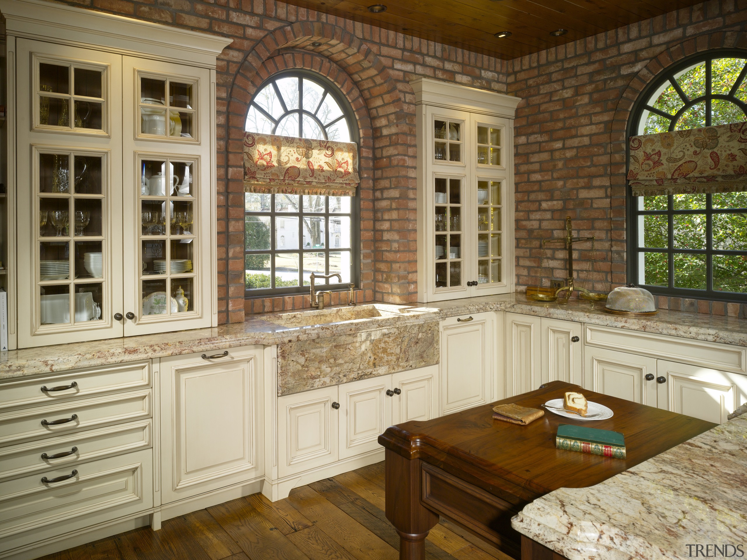 brick walls surrounding arched windows, white cabinets and cabinetry, countertop, cuisine classique, estate, home, interior design, kitchen, window, brown, orange