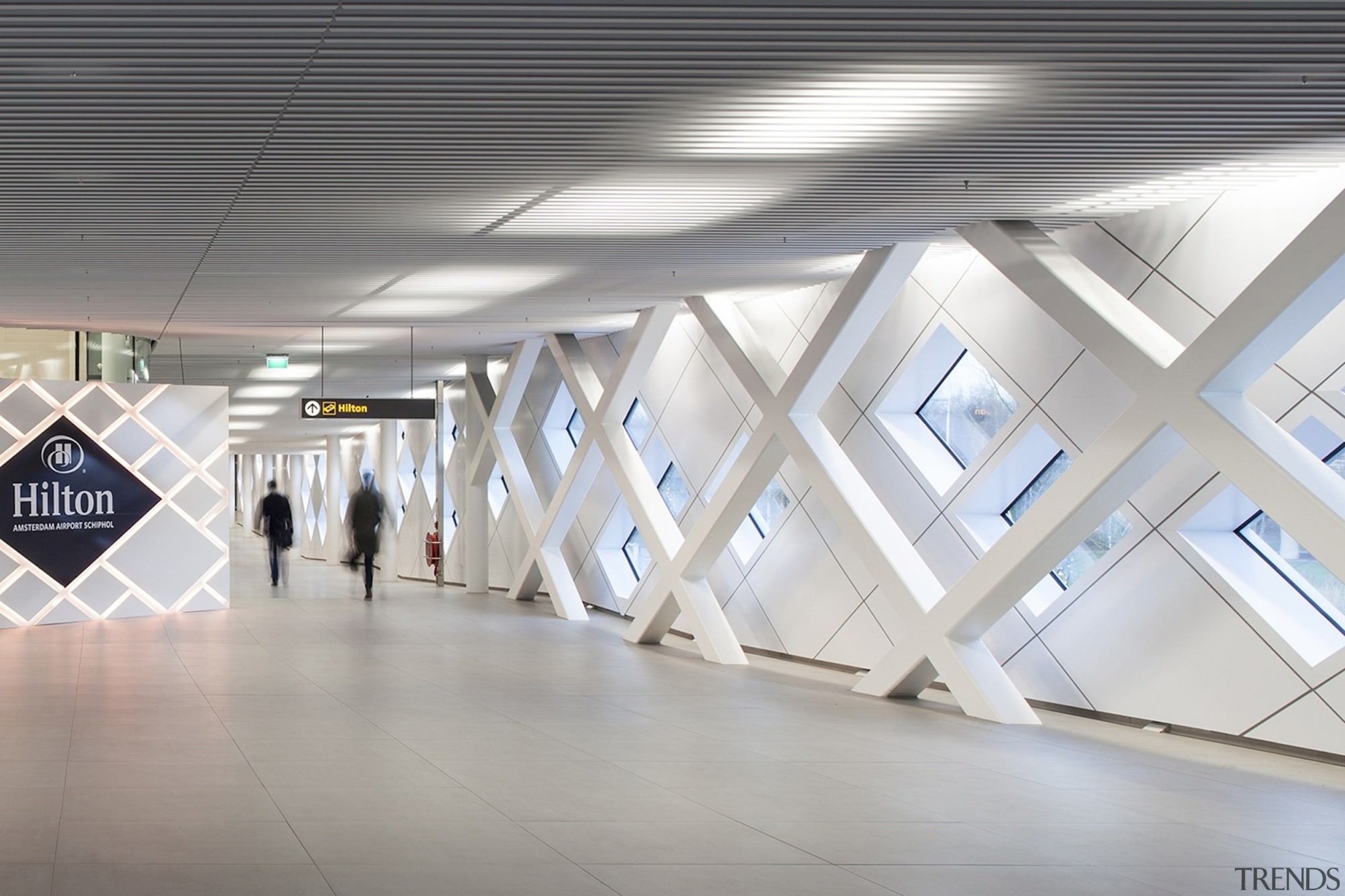 This hallway certainly echoes the airport terminal aesthetic architecture, ceiling, daylighting, floor, interior design, product design, structure, tourist attraction, gray