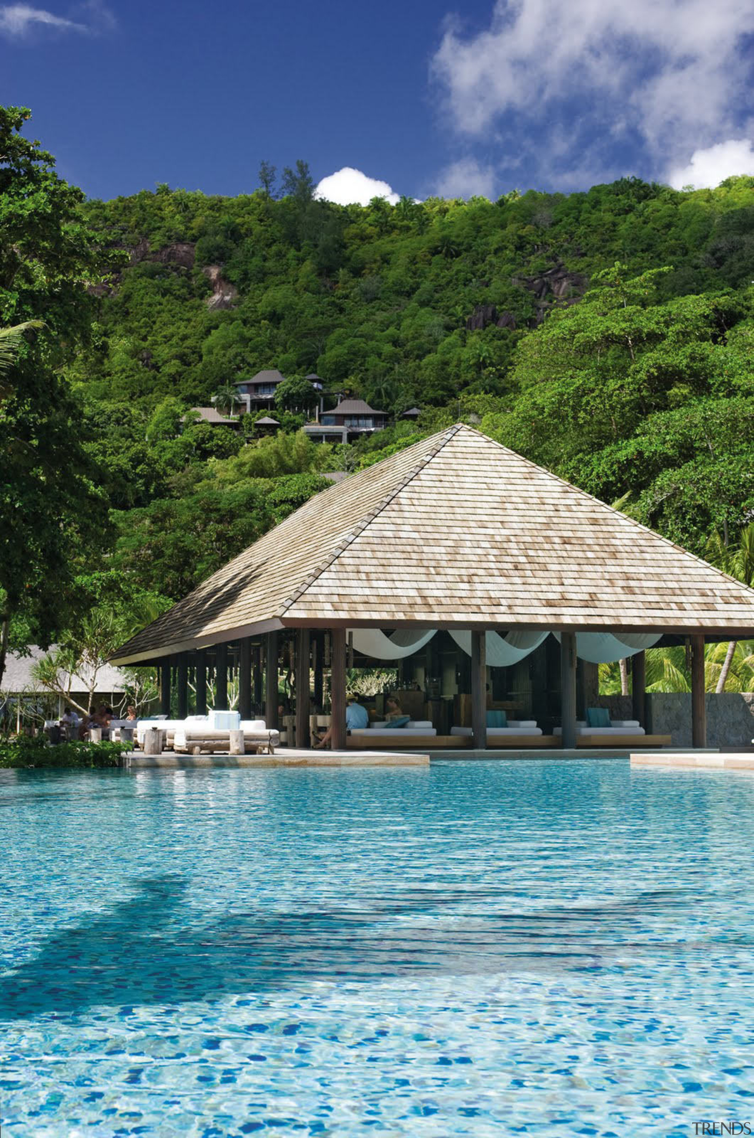 View of Four Seasons Seychelles high-end resort - bay, caribbean, cloud, lagoon, leisure, ocean, resort, resort town, sea, sky, swimming pool, tourism, tree, tropics, vacation, water