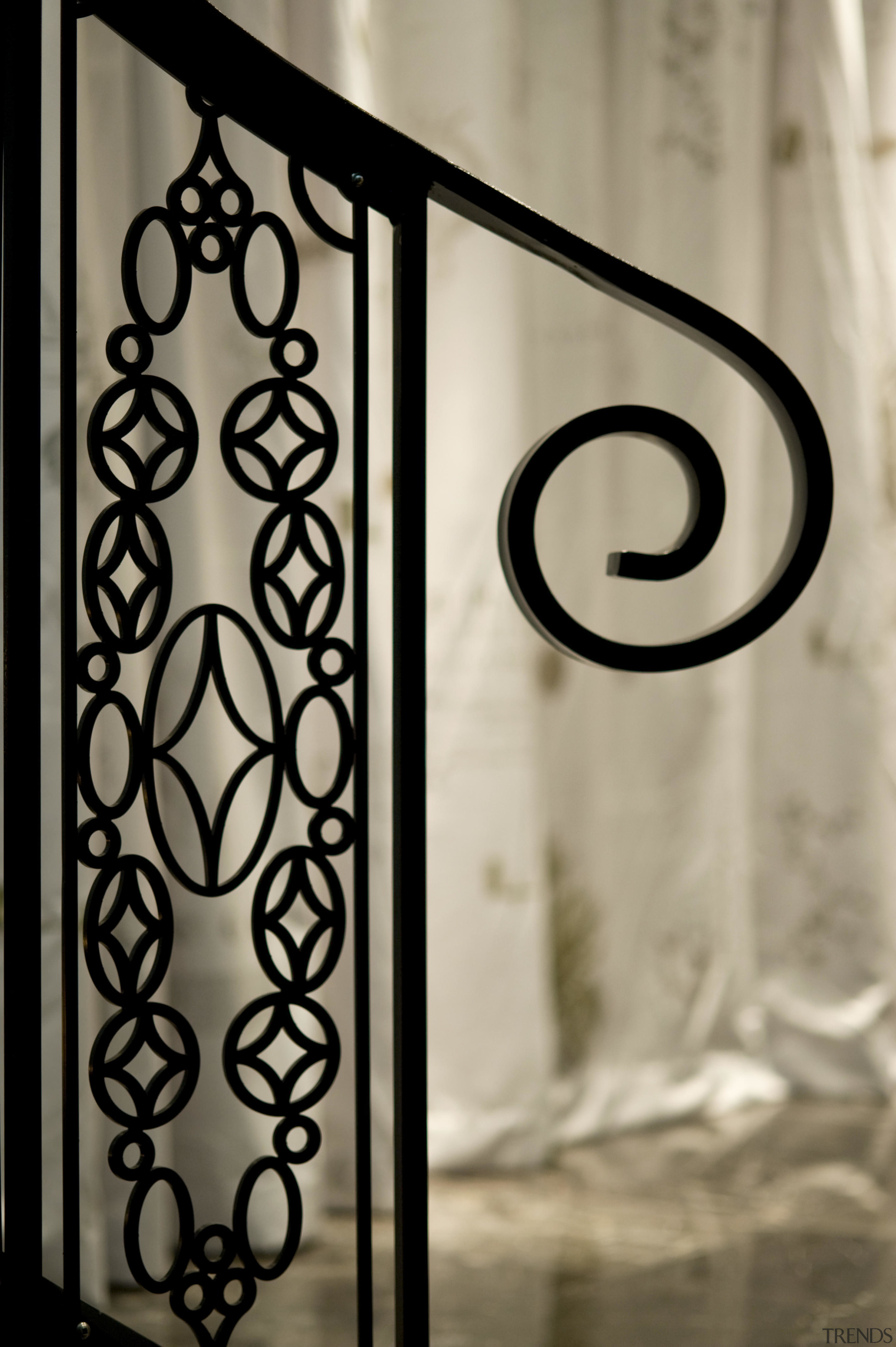 A decorative motif features throughout the interior. The font, glass, handrail, iron, window, orange, brown, black