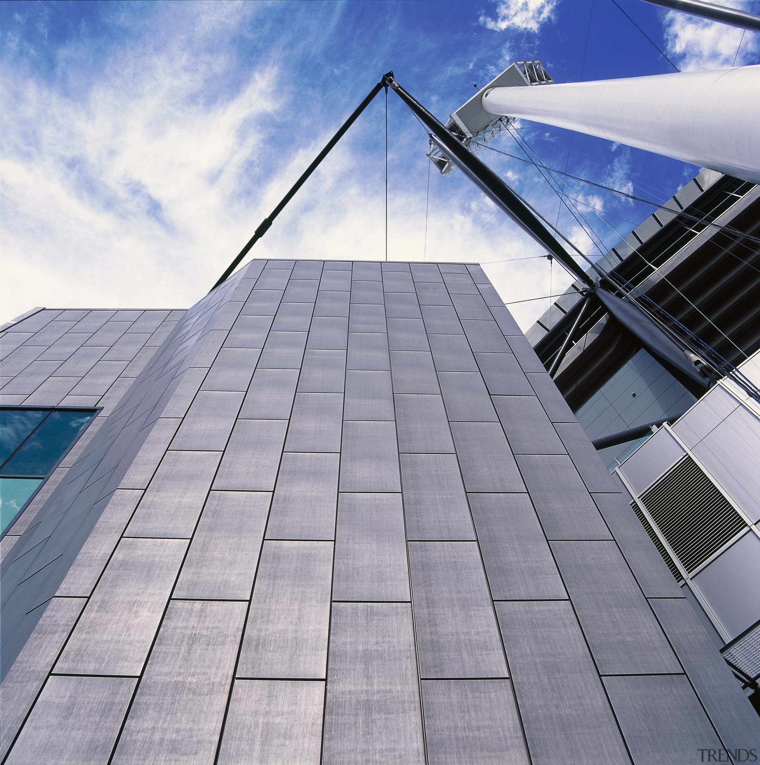 View of zinc panels on facade of stadium. architecture, building, cloud, daylighting, daytime, facade, line, roof, sky, skyscraper, structure, gray