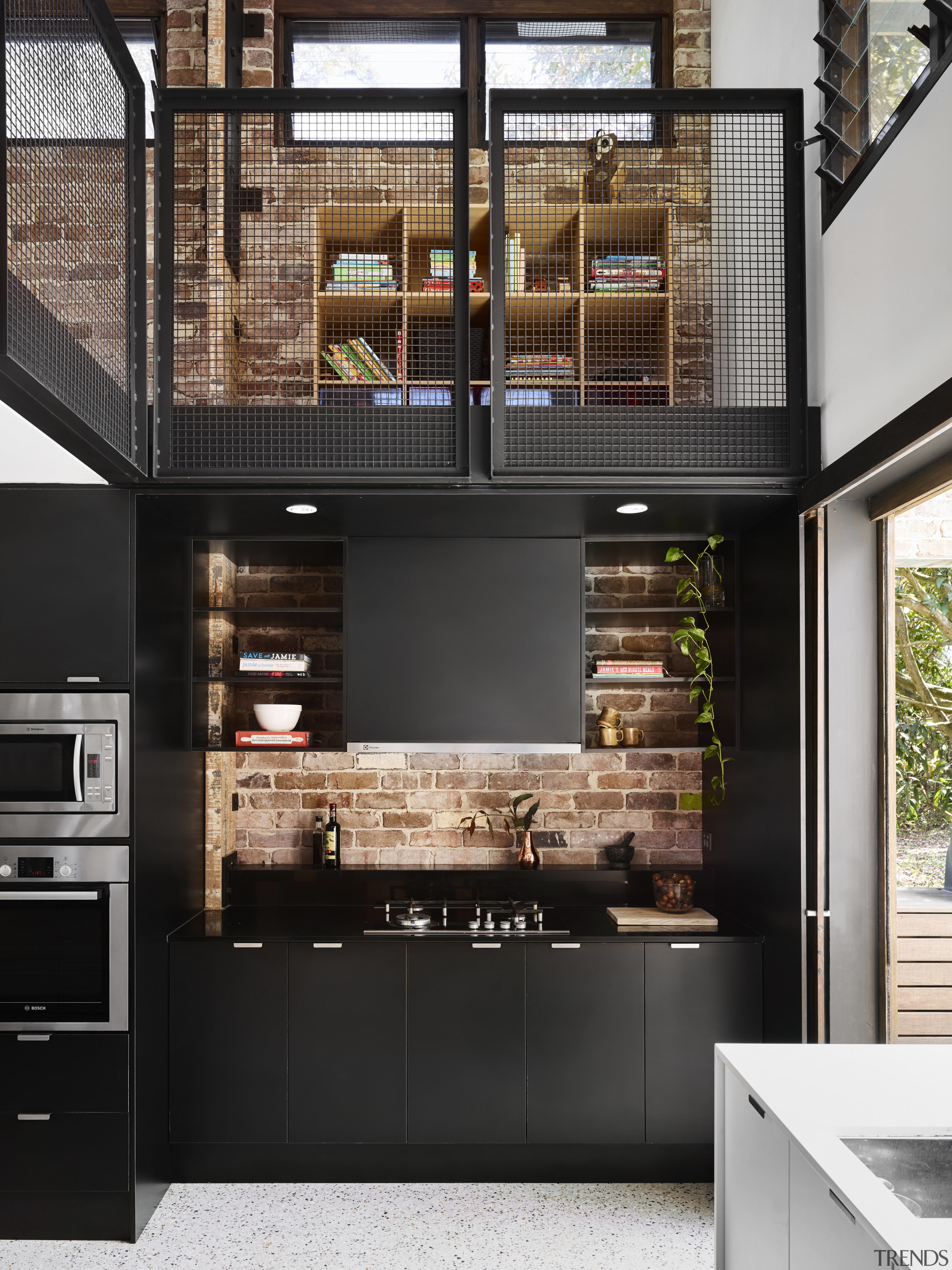 On this project by Maytree Studios, the recycled countertop, interior design, kitchen, black