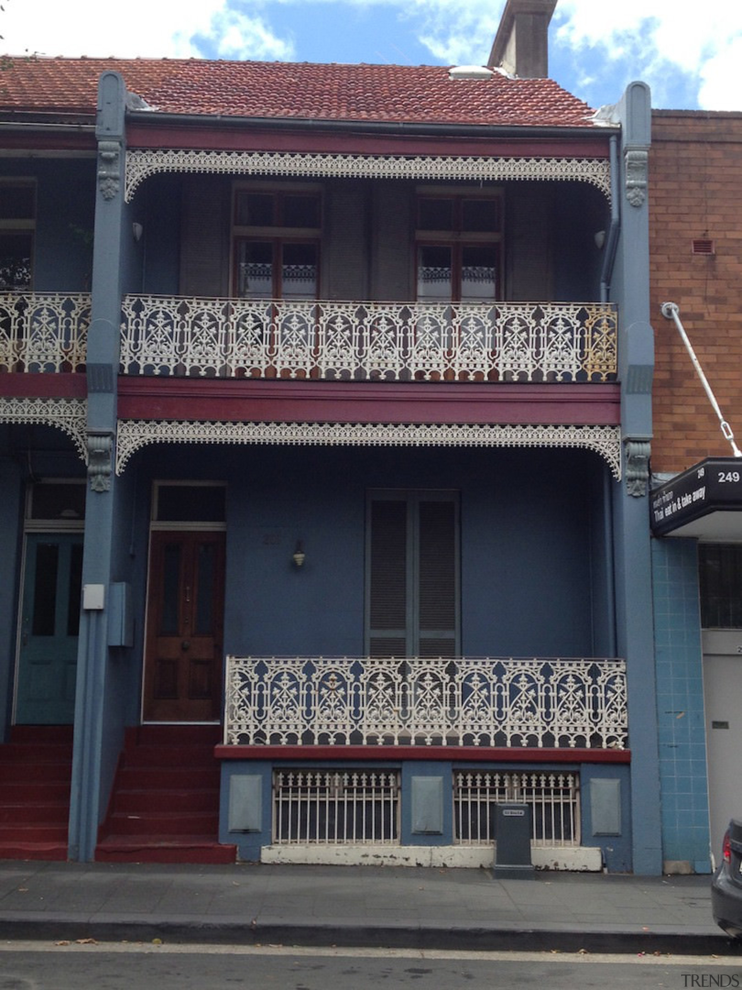 The original facade of this terrace house has architecture, balcony, boarding house, building, commercial building, facade, home, house, neighbourhood, property, real estate, residential area, town, window, black