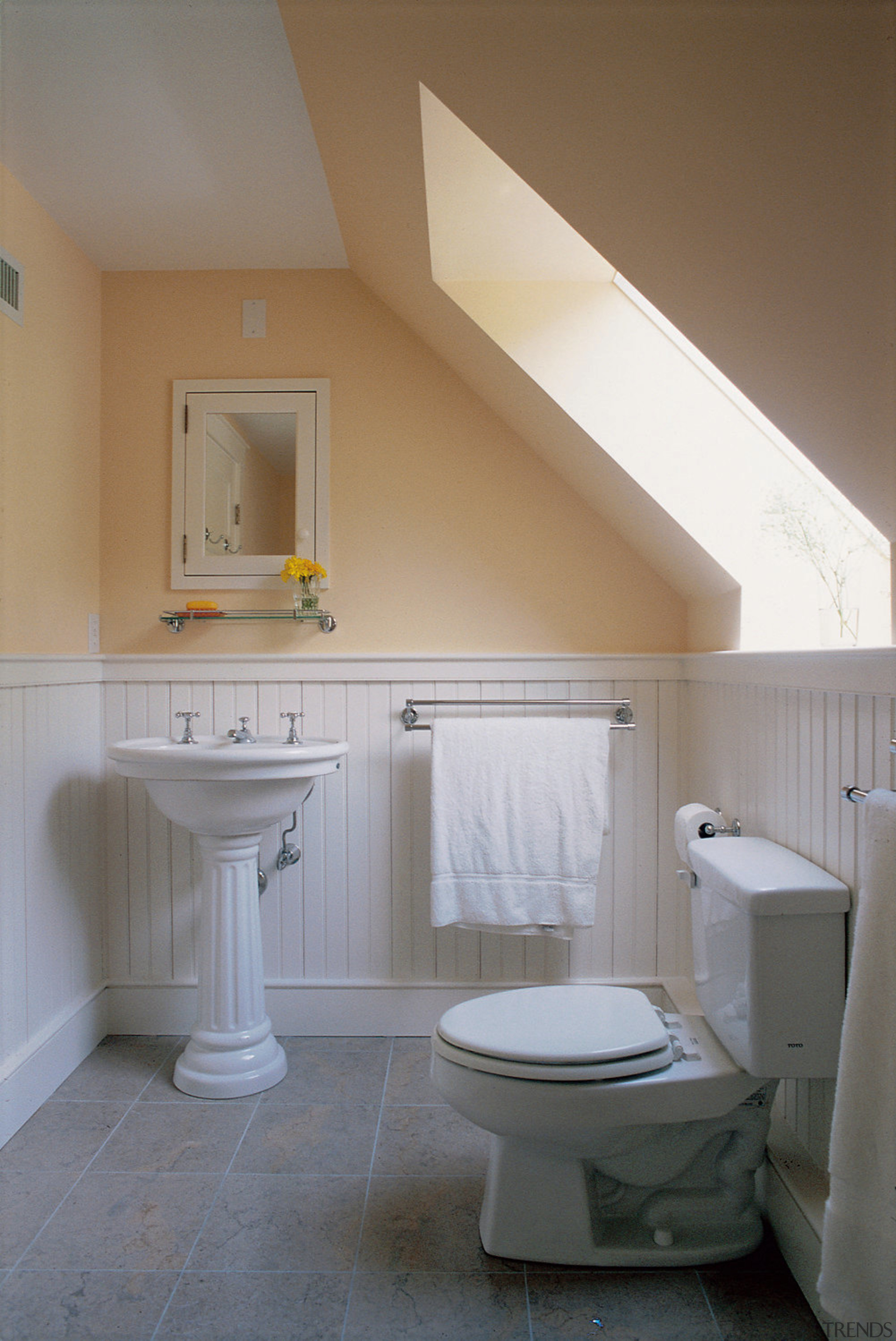 View of the bathroom installed with a skylight architecture, bathroom, bathroom accessory, bathroom cabinet, bathroom sink, bidet, daylighting, floor, home, house, interior design, plumbing fixture, product design, real estate, room, sink, tap, tile, toilet, toilet seat, wall, gray, brown