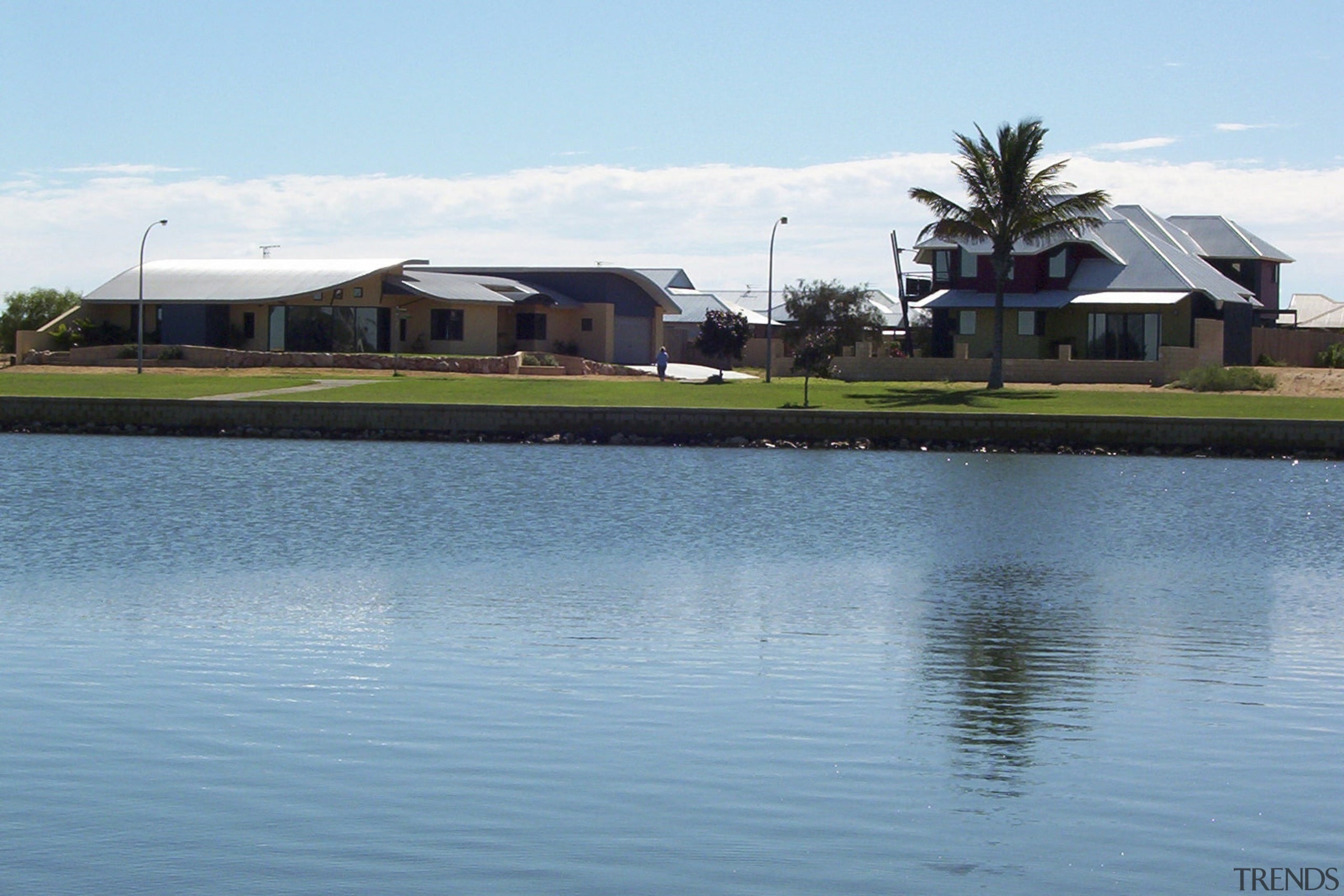 View of the Carnarvon doreshore in Gascoyne which estate, home, house, lake, land lot, leisure, palm tree, property, real estate, reflection, reservoir, resort, sky, swimming pool, water, water resources, waterway, teal
