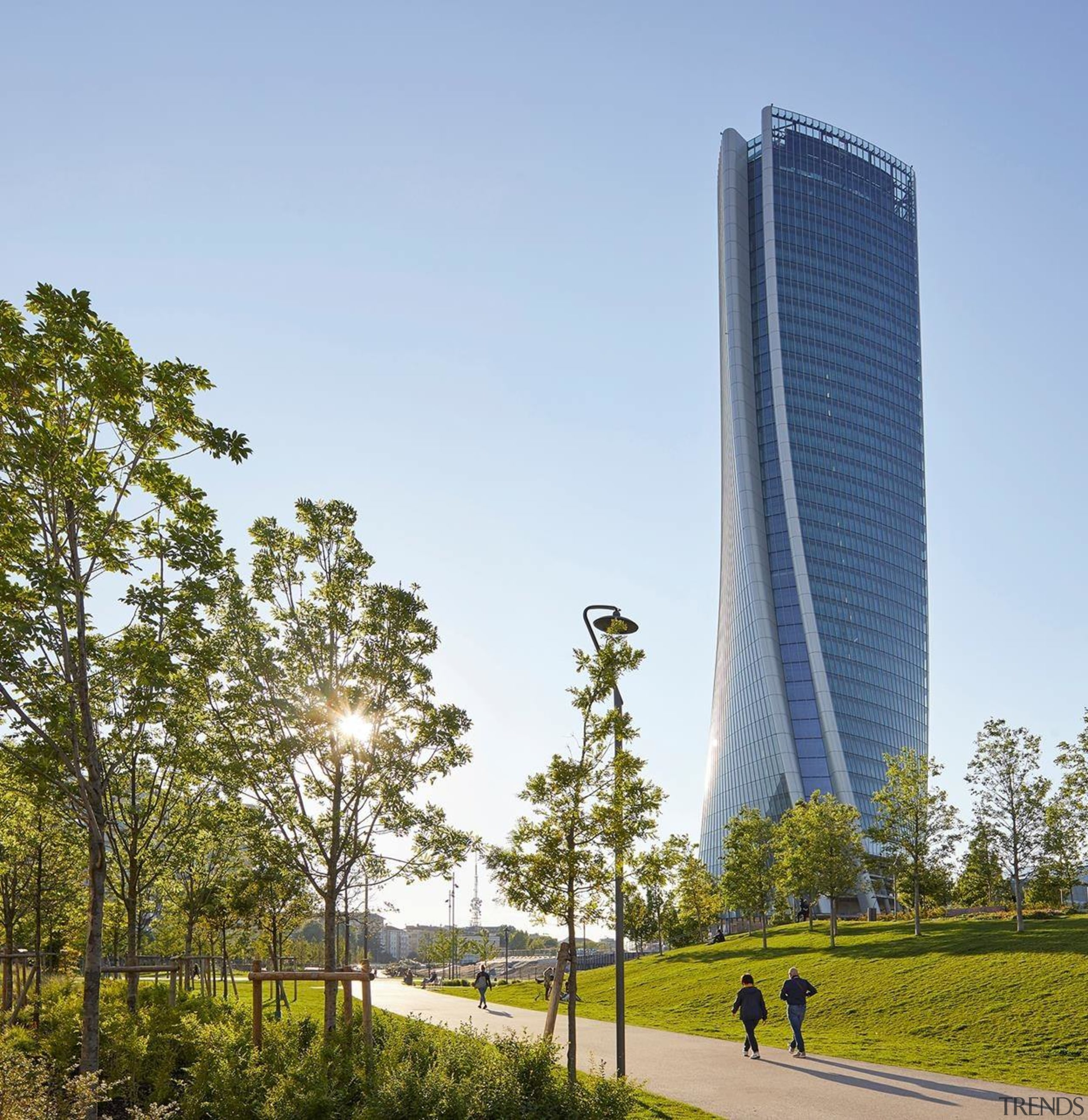 The new tower rises up above Milan - architecture, building, condominium, corporate headquarters, daytime, metropolitan area, sky, skyscraper, tower, tower block, tree, teal