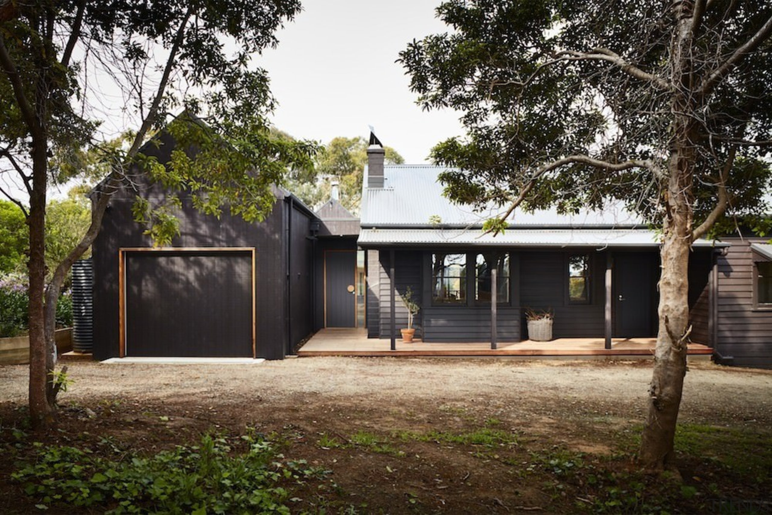 A single garage sits alongside the house - architecture, cottage, facade, farmhouse, home, house, property, real estate, residential area, tree, black, brown