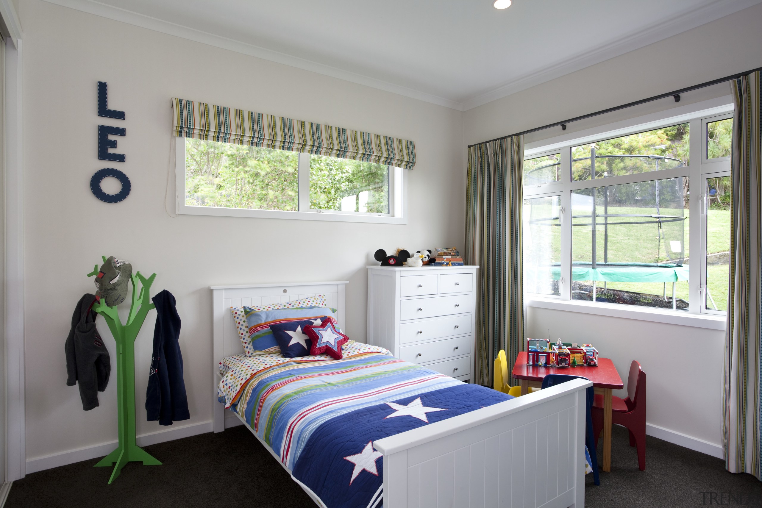 Child's room with white walls and colourful duvet. bedroom, home, house, interior design, property, real estate, room, textile, window, gray