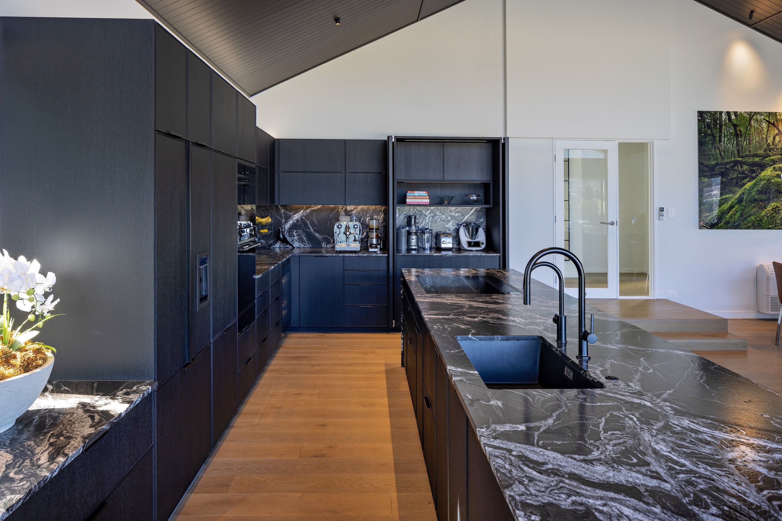 The exotic benchtop stone is continued as splashbacks 