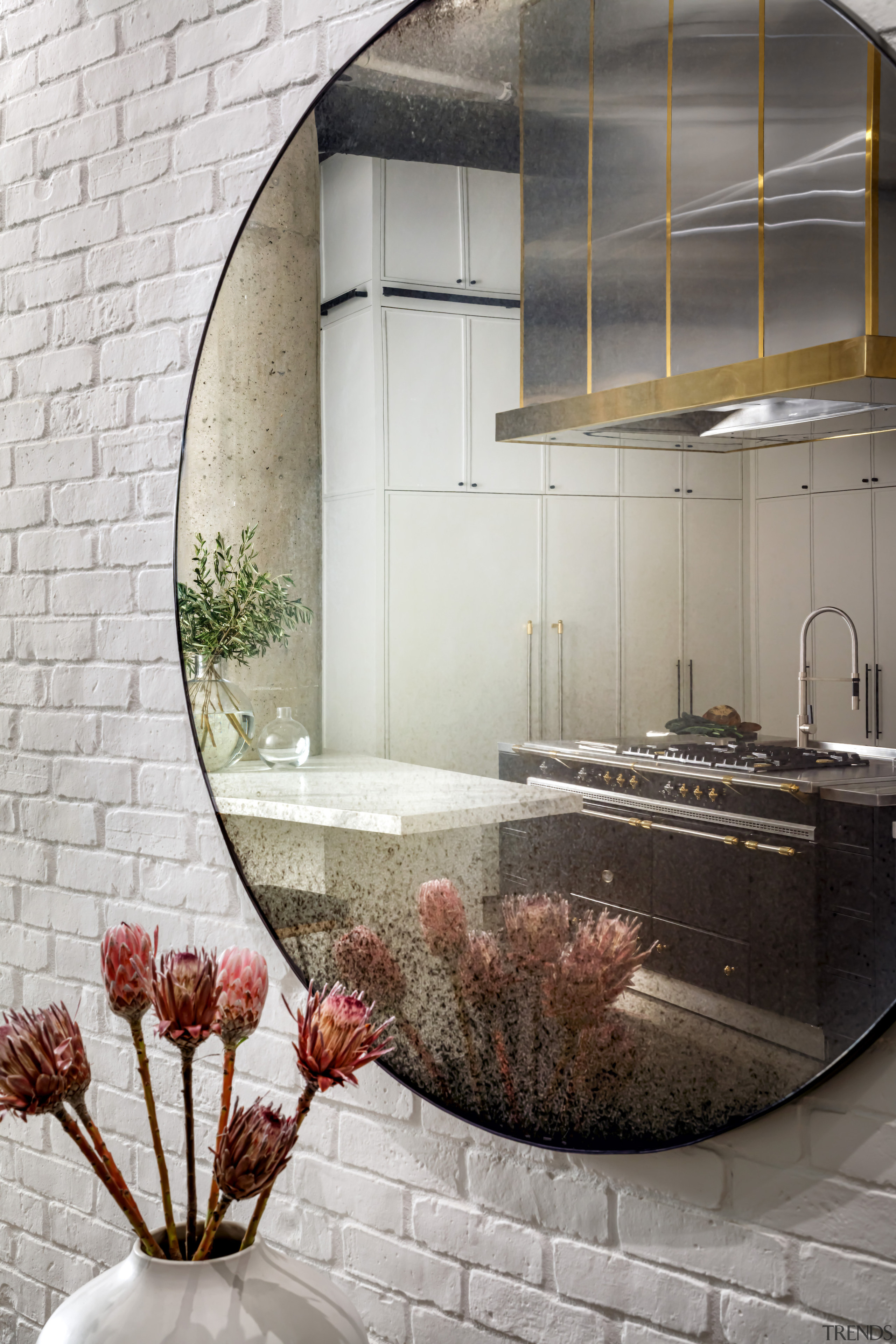 The semi-industrial kitchen seen in reflection. 