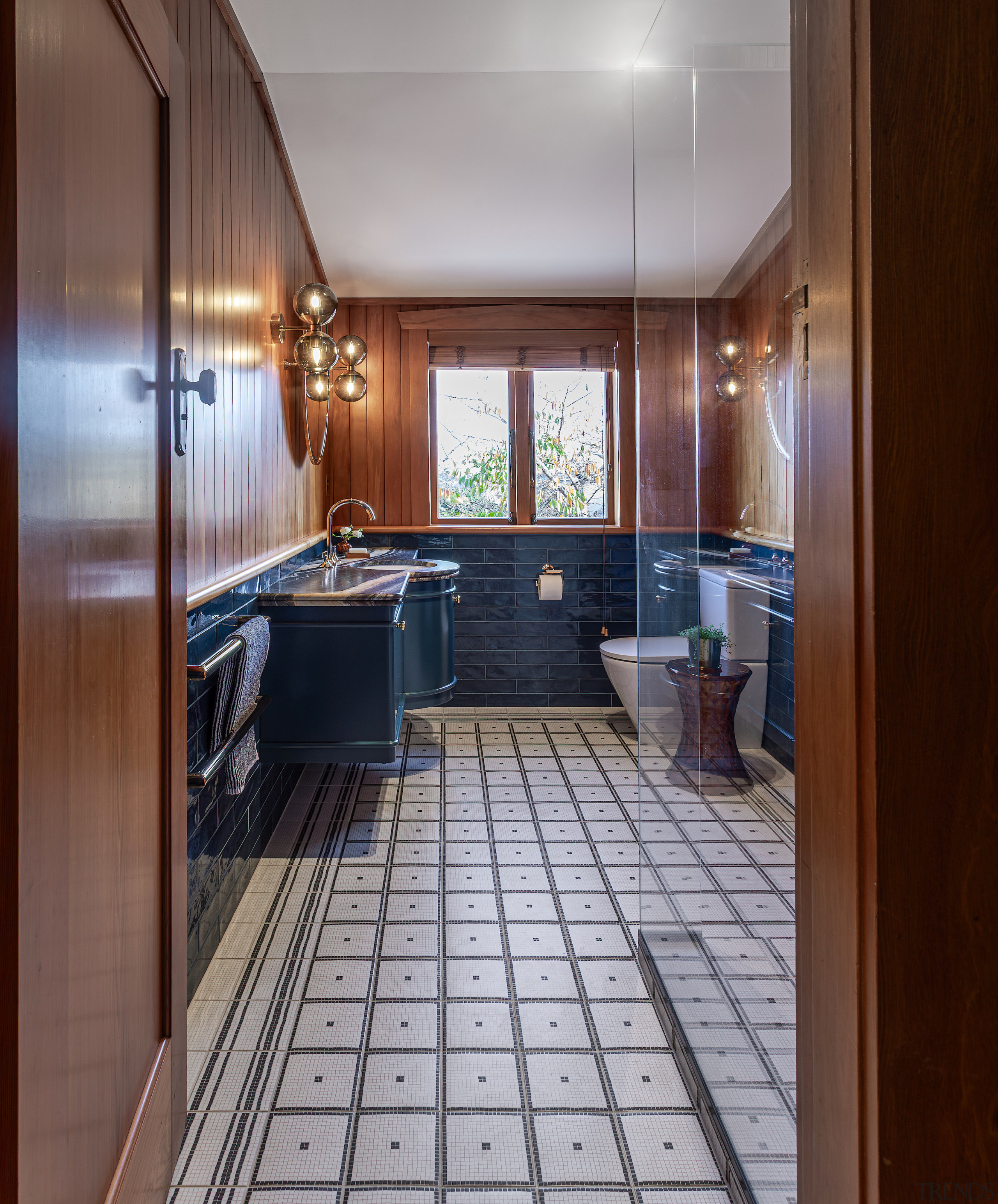 Entrance into the ship-shape bathroom with designer sconces 