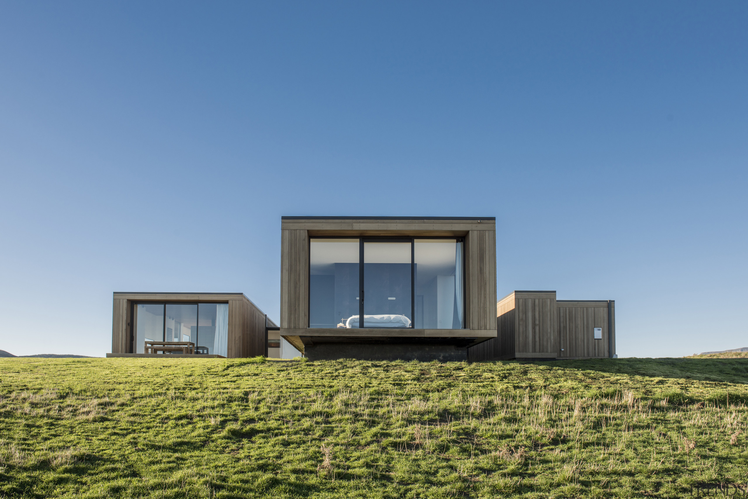 Comprised of three wings and a connecting gallery architecture, cottage, elevation, facade, farmhouse, home, house, property, real estate, sky, villa, teal