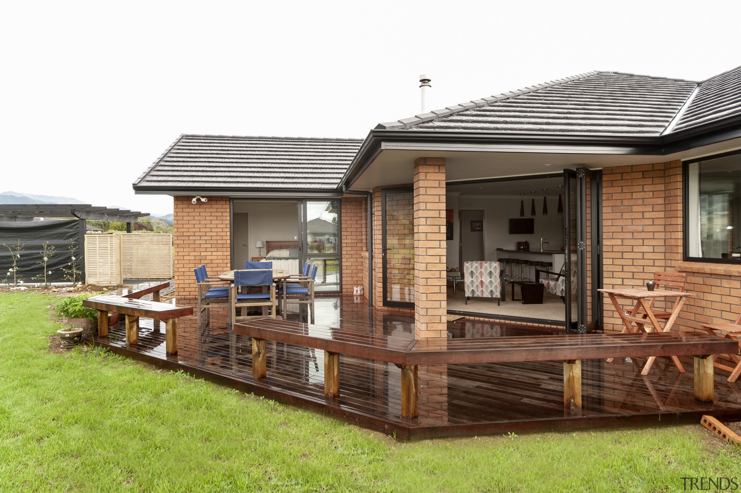 Monier Heatherstone brick and Linea weatherboards feature on backyard, cottage, deck, home, house, outdoor structure, property, real estate, roof, siding, white, brown