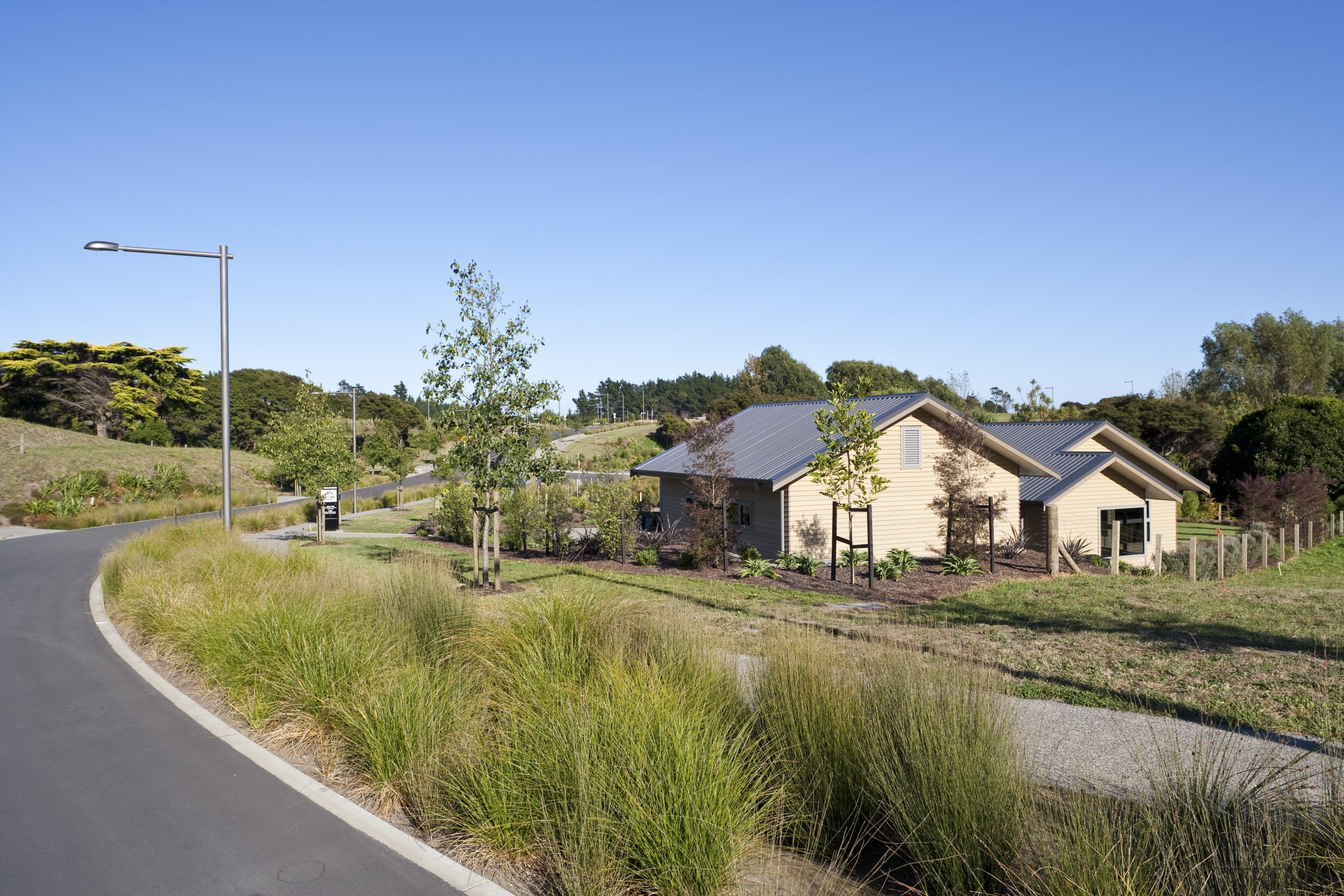 Exterior view of landscaped area surrounding the Ferndale cottage, estate, farmhouse, home, house, land lot, landscape, plant, property, real estate, residential area, rural area, sky, suburb, tree, villa, village, teal, brown