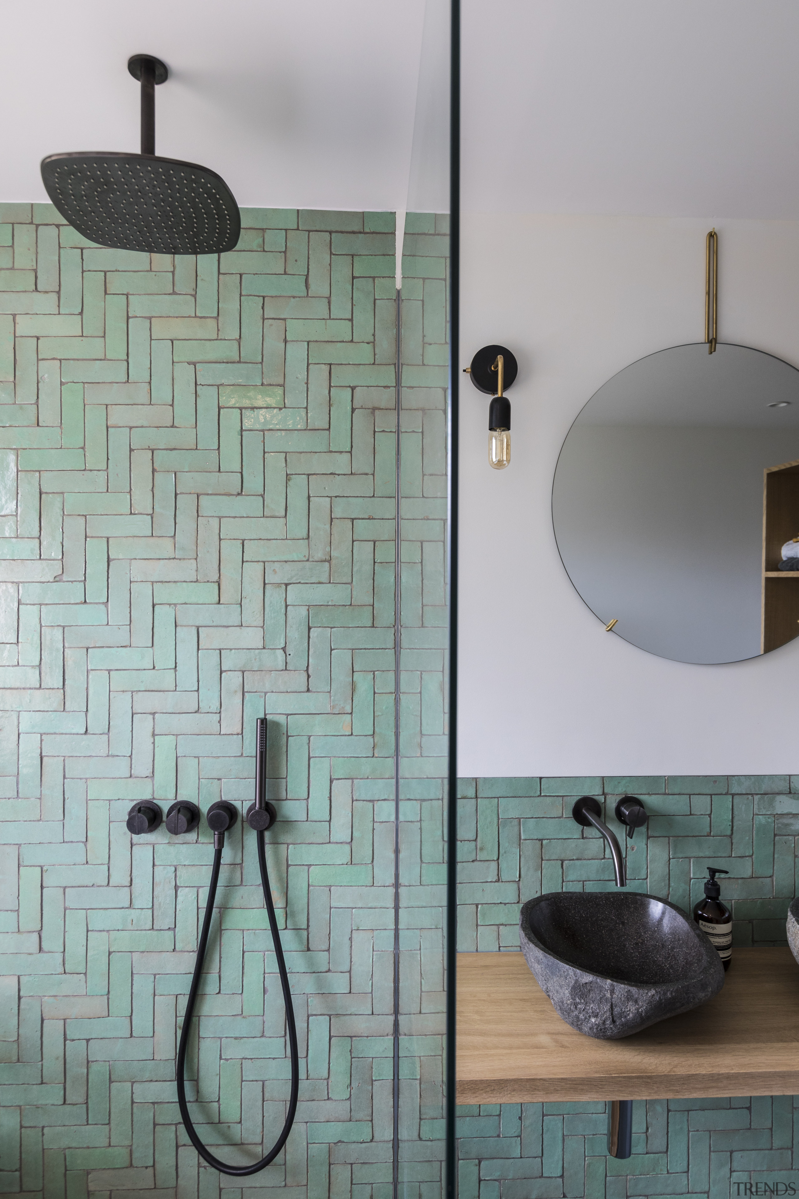 ​​​​​​​Black, brushed metal faucets and shower fittings in architecture, bathroom, bathroom sink, flooring, interior design, plumbing fixture, shower, tile, wall, gray, Cantero Architecture