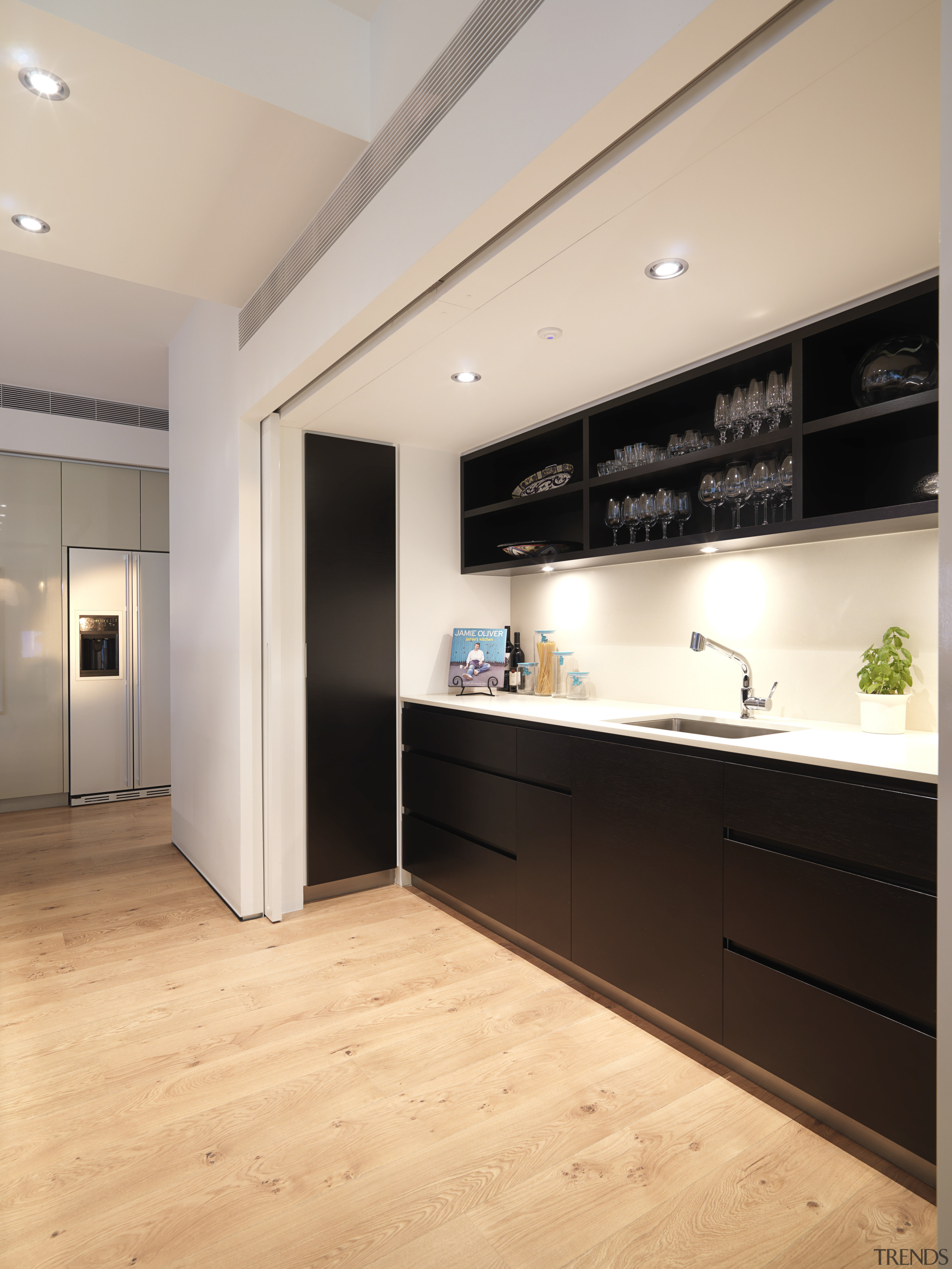 View of kitchen which features a kitchen island ceiling, floor, flooring, interior design, kitchen, real estate, wood flooring, gray, orange