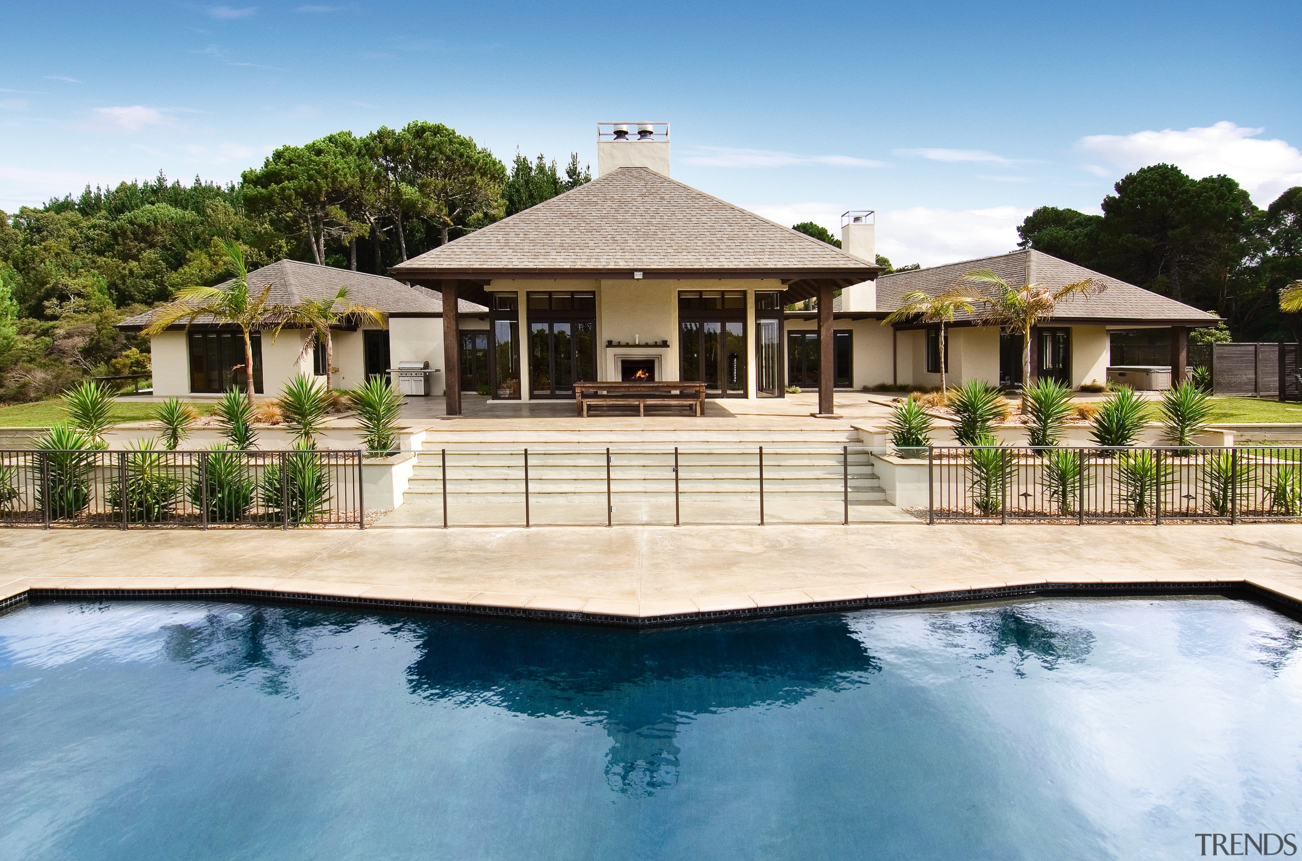 View of this outdoor pavillion that has a backyard, cottage, elevation, estate, facade, home, house, mansion, outdoor structure, property, real estate, residential area, resort, swimming pool, villa, white, teal