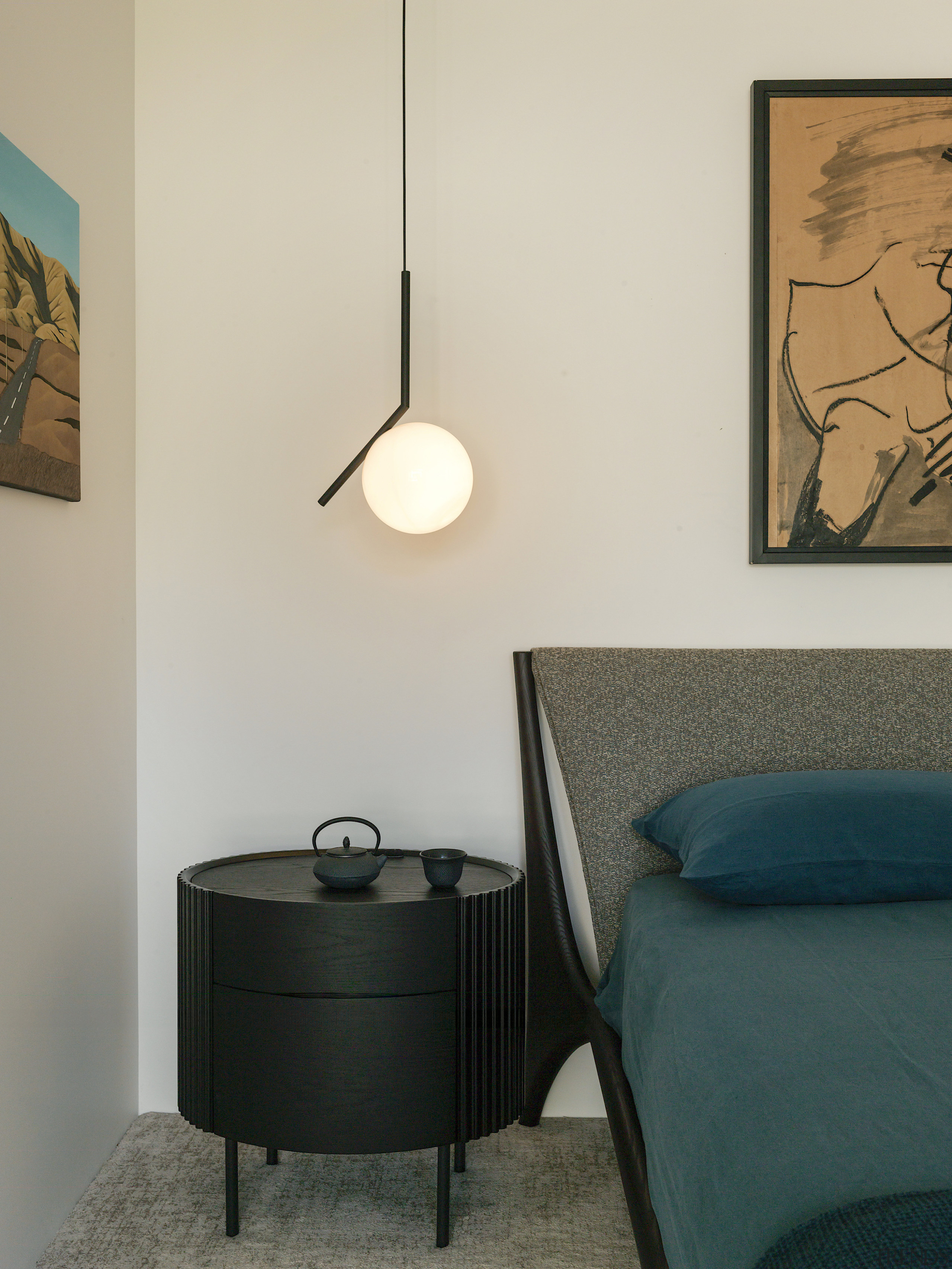 Oval timber bedside tables and curated light fittings 