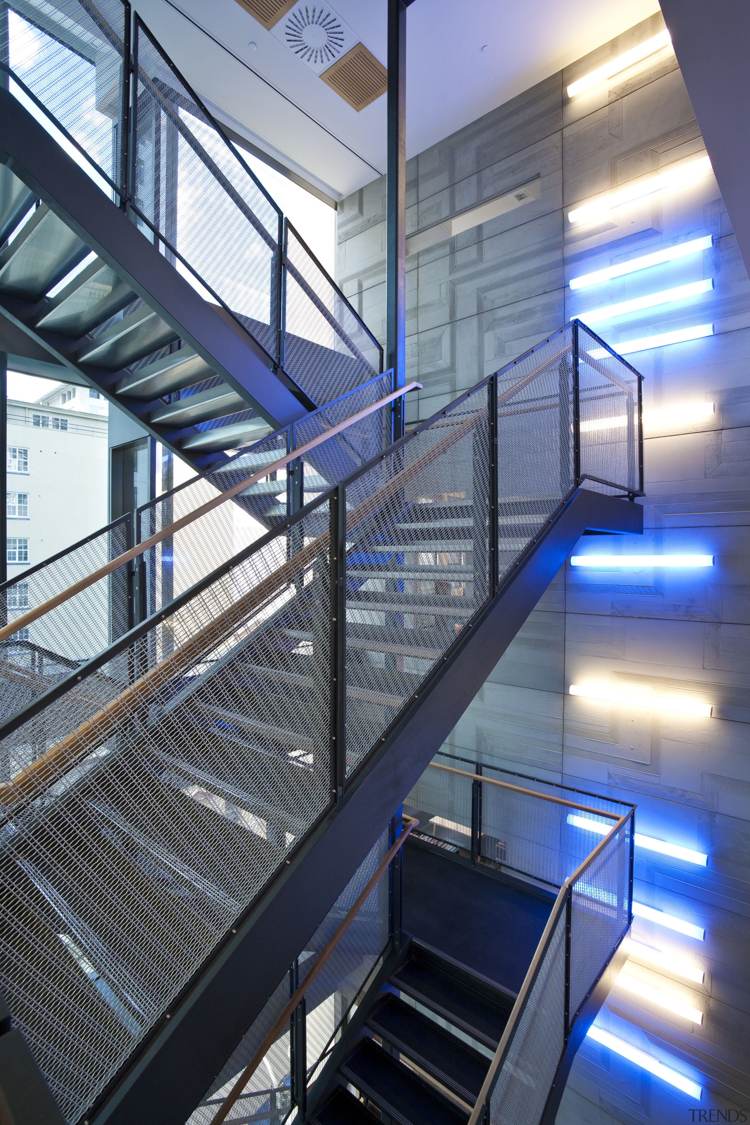 The offices of BNZ feature a combination of architecture, building, condominium, daylighting, glass, handrail, stairs, steel, structure, blue