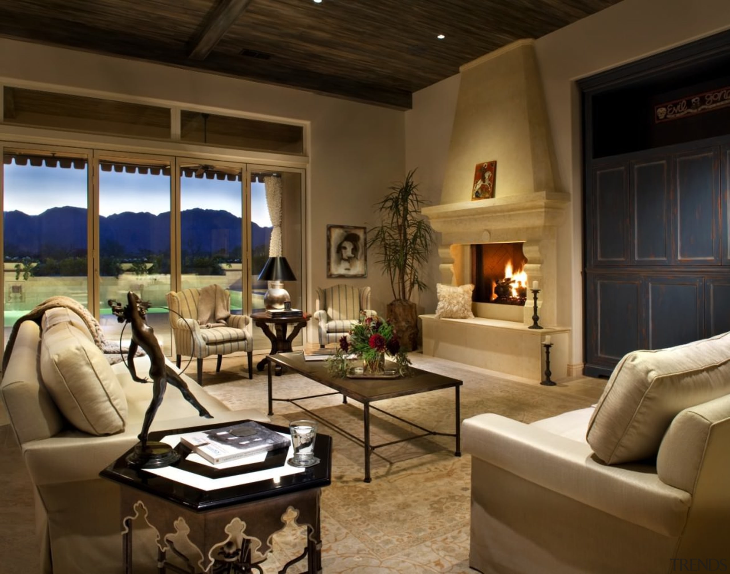 The living area features a fireplace and an home, interior design, living room, real estate, room, brown