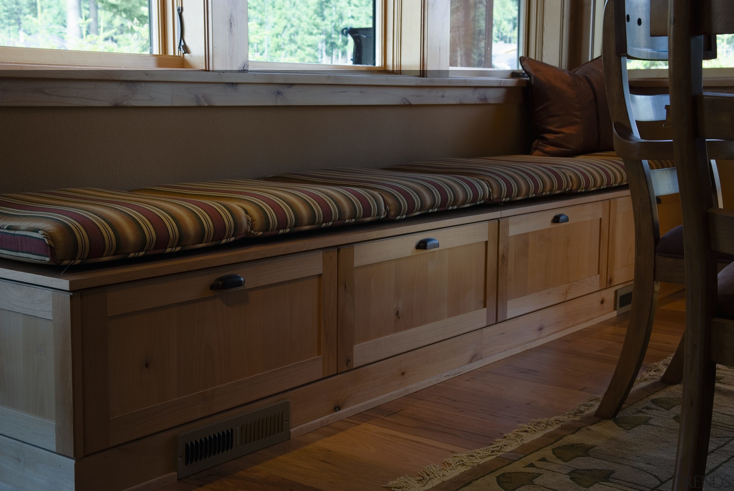A view of this windo bench seat, all furniture, table, wood, wood stain, brown