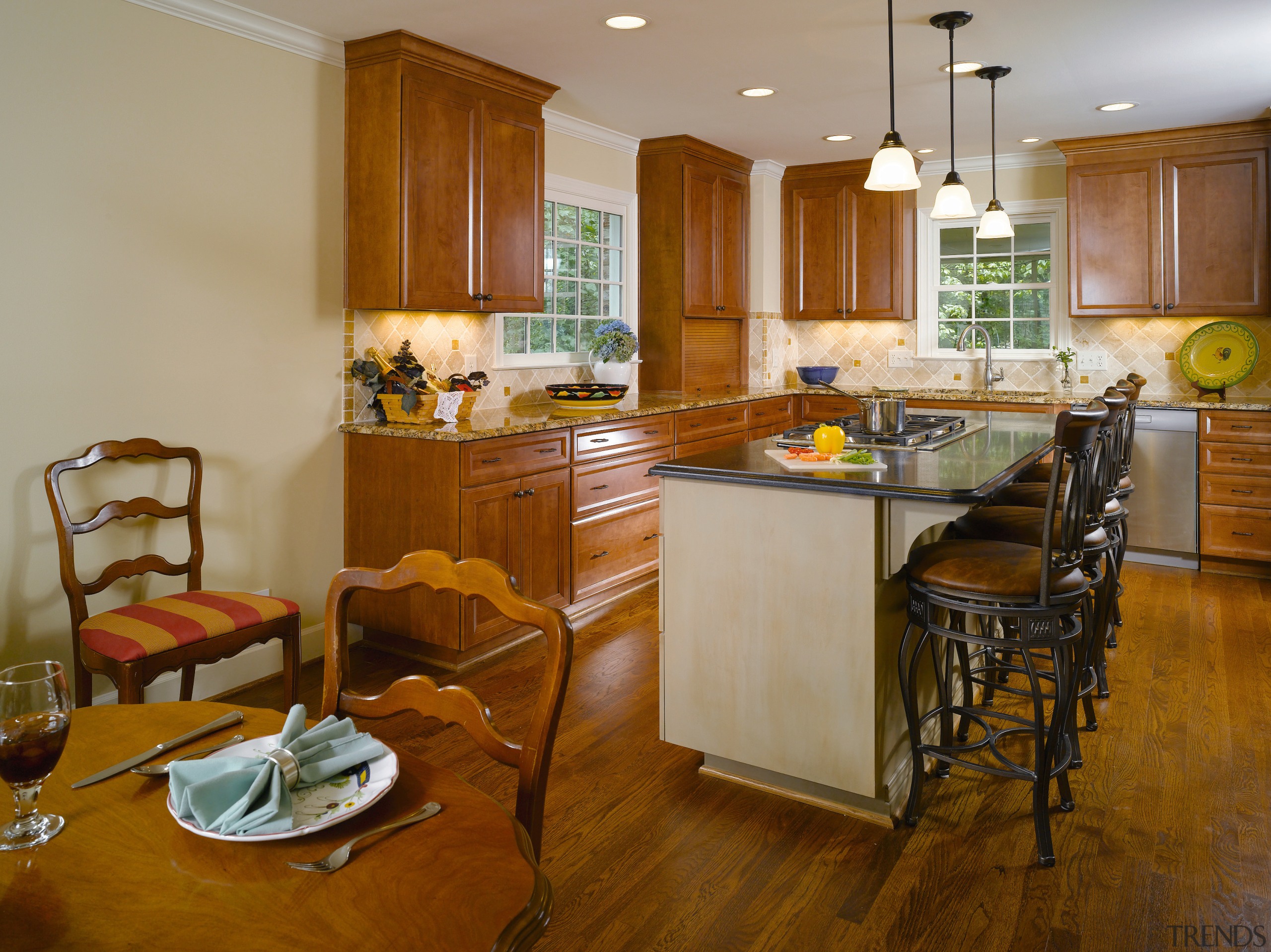 The kitchen island provides a food npreperation and cabinetry, countertop, cuisine classique, floor, flooring, hardwood, interior design, kitchen, real estate, room, wood flooring, brown, orange