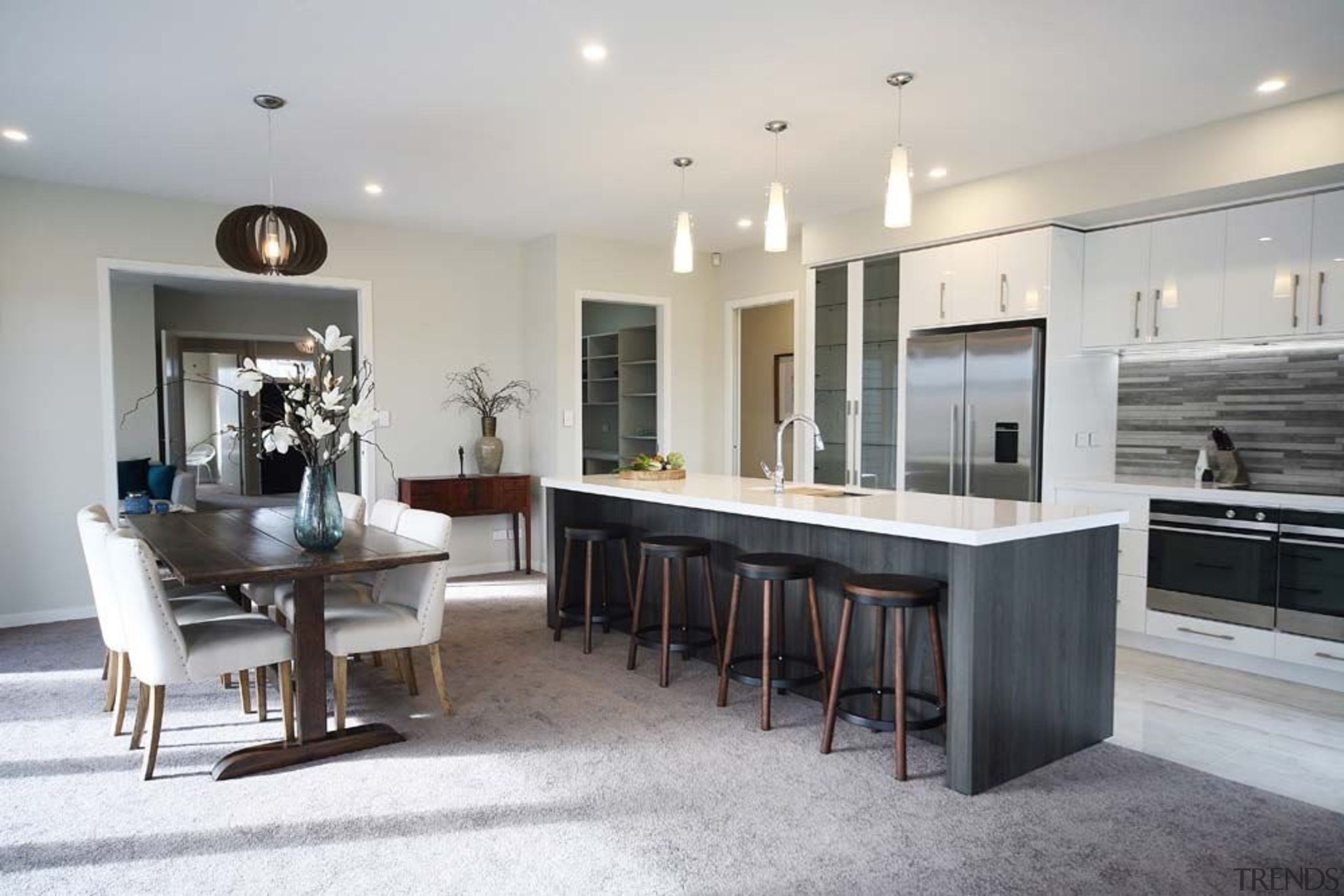 A large entertainers kitchen with walk-in pantry, featuring countertop, cuisine classique, floor, flooring, furniture, interior design, kitchen, real estate, room, table, gray